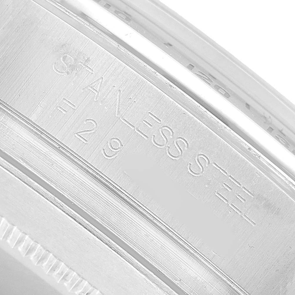 The image shows a close-up of the engraved inner bezel of a Rolex Daytona 116520 Men's Stainless Steel Black Dial watch, indicating "STAINLESS STEEL."