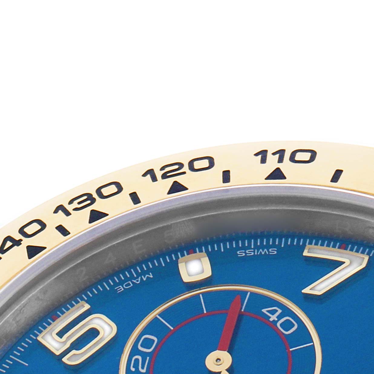 The image shows a close-up of the Rolex Daytona 116503 Men's Steel and Gold (two tone) Blue Dial's bezel and part of the blue dial, highlighting the tachymeter scale.