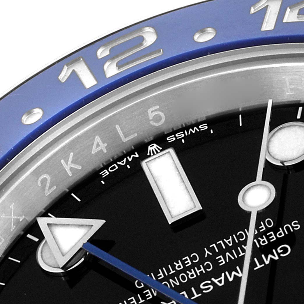 This close-up photo of a Rolex GMT-Master 126710 Men's Stainless Steel Black Dial 126710 Men's Stainless Steel Black Dial watch shows a partial view of the bezel, dial, and hour hand.