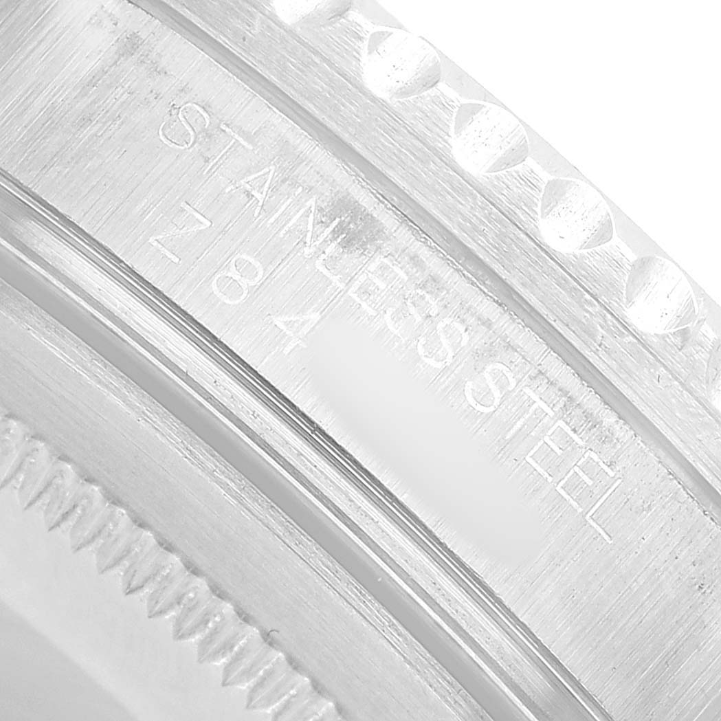 The image shows a close-up of the bezel edge and engraving on a stainless steel Rolex GMT-Master 16710 Men's Stainless Steel Black Dial watch.