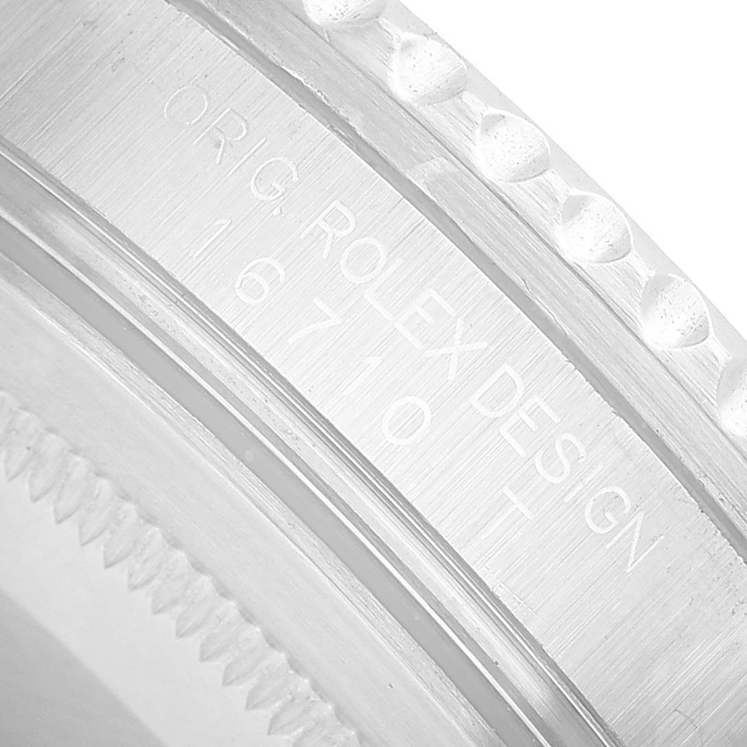 The image shows a close-up of a Rolex GMT-Master 16710 Men's Stainless Steel Black Dial's engraved serial number and design details on the case.