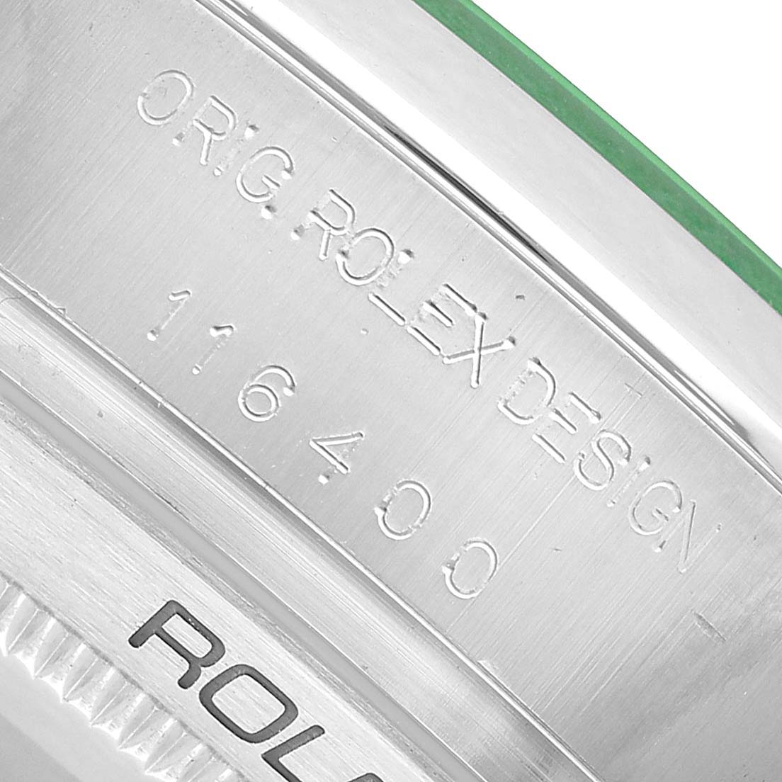 The image shows a detailed close-up of the Rolex Milgauss 116400GV Men's Stainless Steel Black Dial model's engraved case side, highlighting the "ORIG ROLEX DESIGN" and model number.