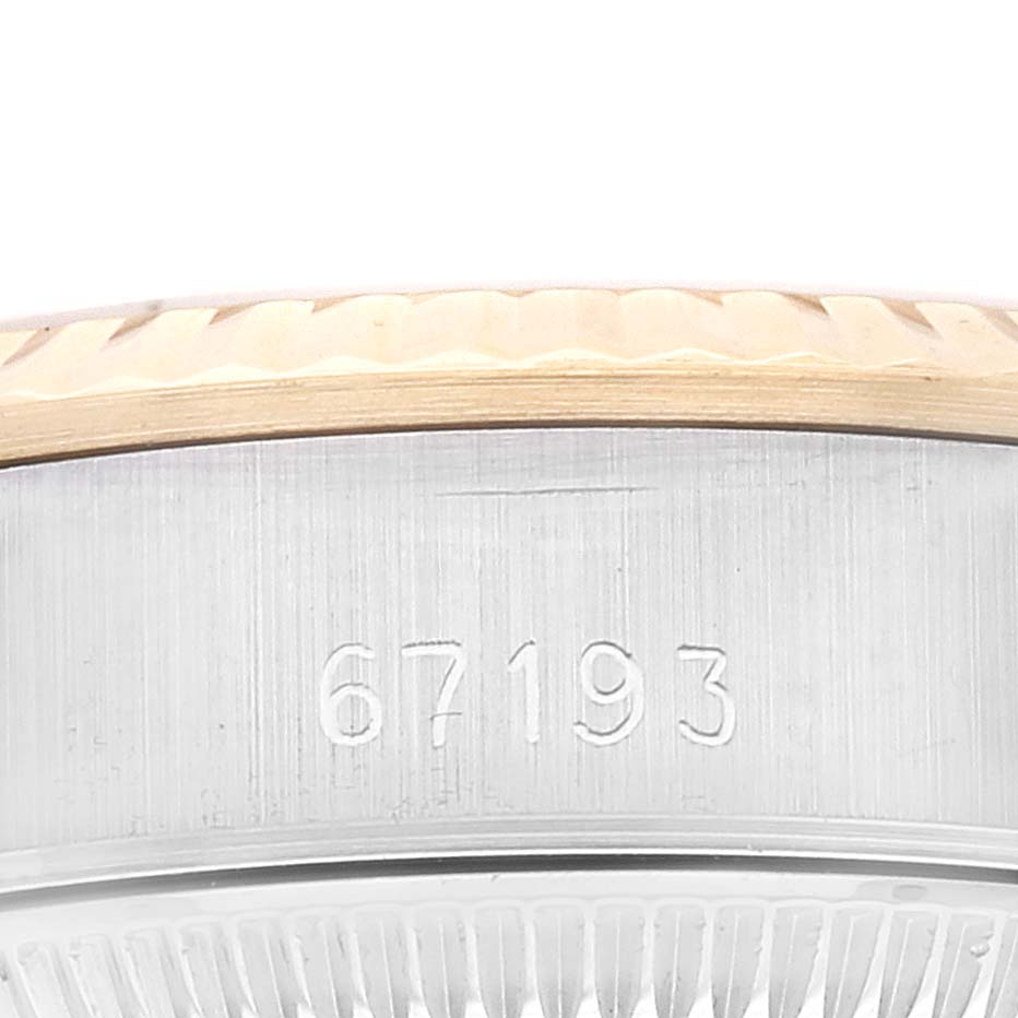 This image shows the side of a Rolex Oyster Perpetual 67193 Women's Steel and Gold (two tone) Silver Dial 67193 Women's Steel and Gold (two tone) Silver Dial watch case with the engraved model number "67193."