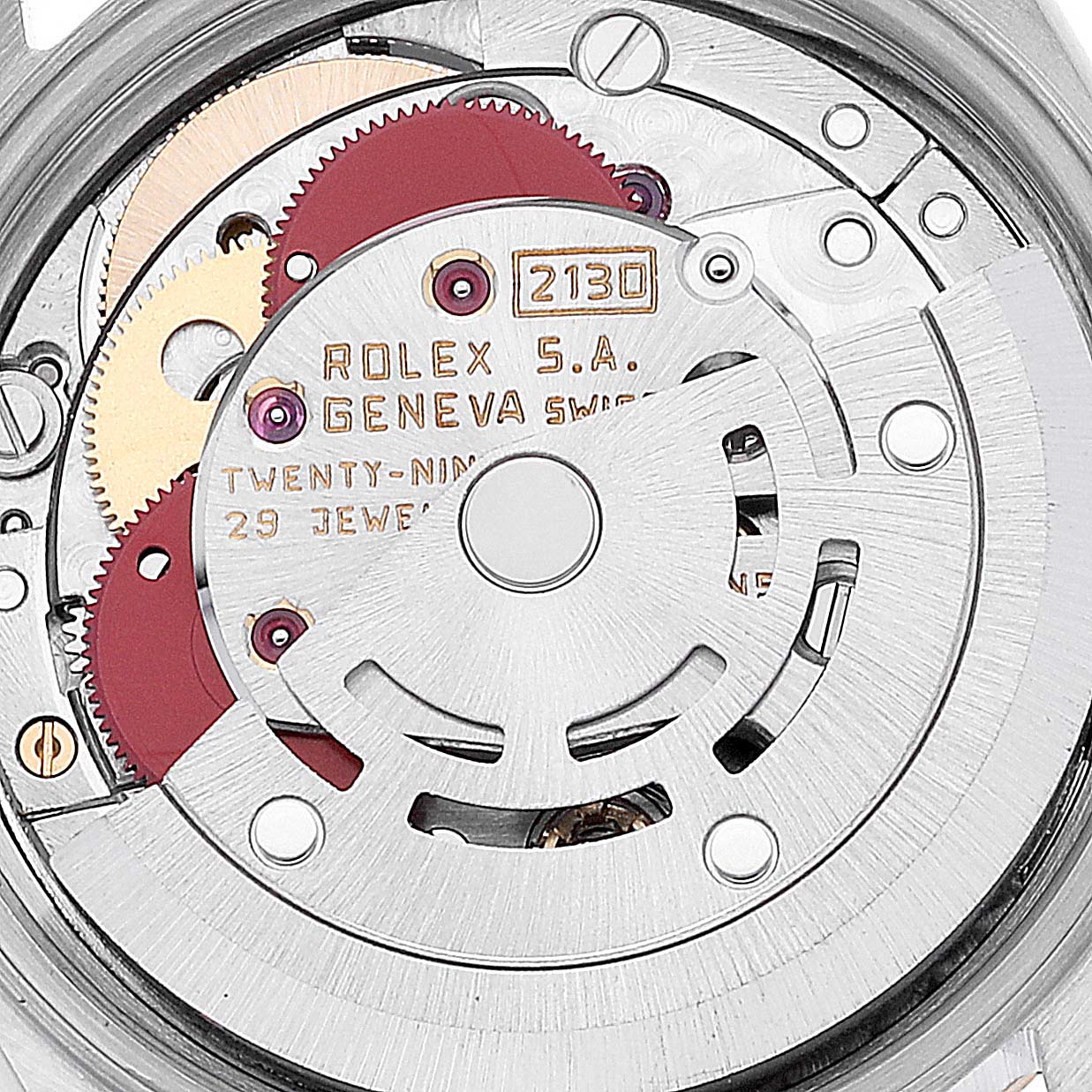 This image shows the internal mechanism of a Rolex Oyster Perpetual 67193 Women's Steel and Gold (two tone) Silver Dial 67193 Women's Steel and Gold (two tone) Silver Dial watch, displaying gears, jewels, and movement components.