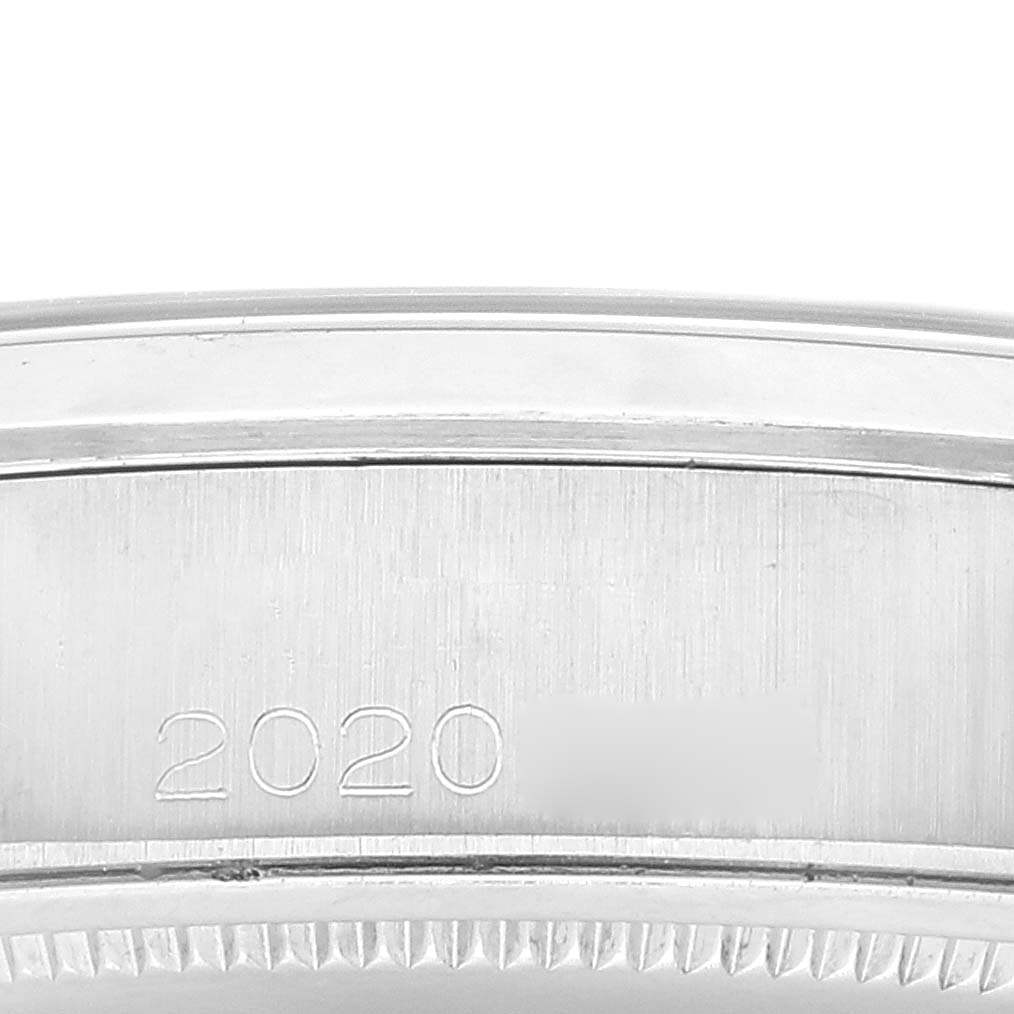 This close-up image shows the side of a Rolex Vintage Collection 6694 Men's Stainless Steel Silver Dial 6694 Men's Stainless Steel Silver Dial watch, highlighting its engraved serial number.