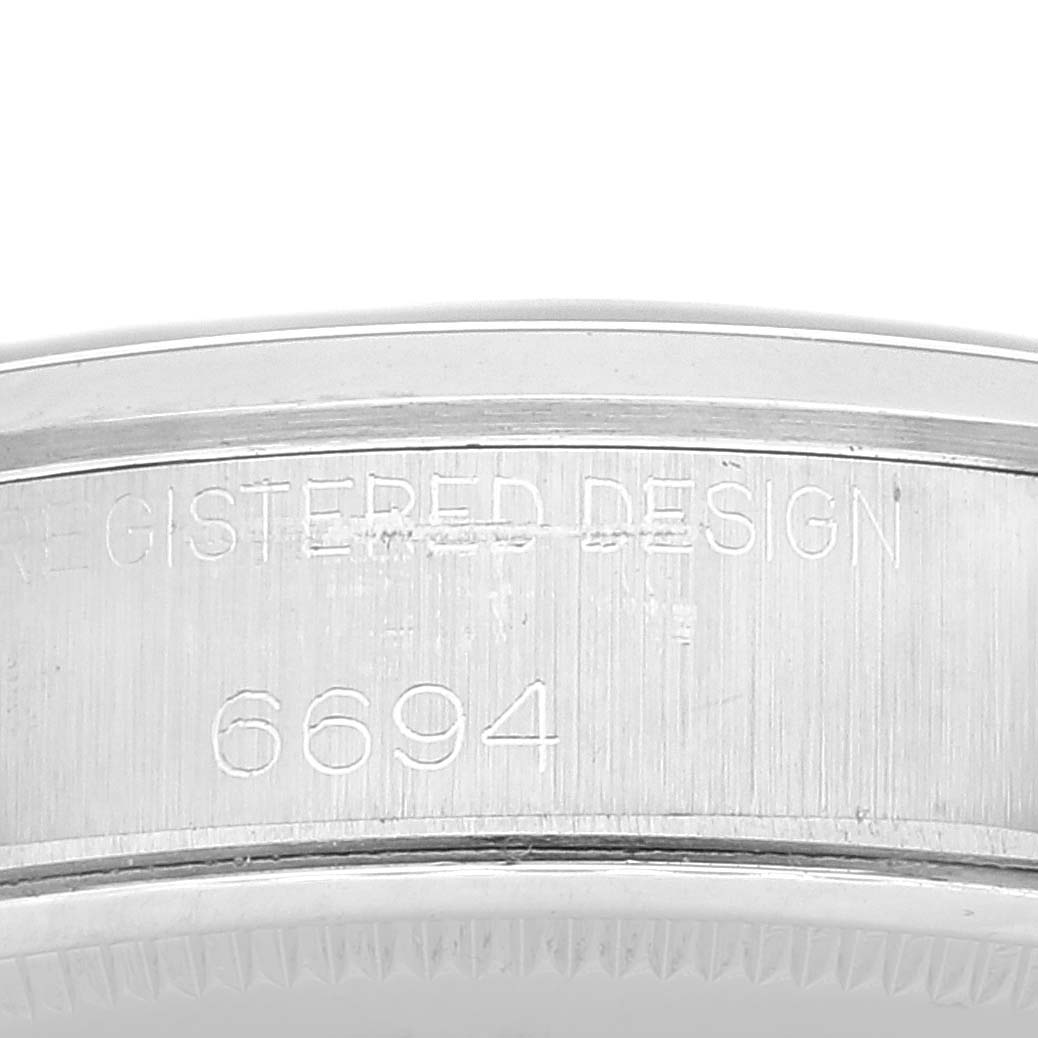 This image shows a close-up of the Rolex Vintage Collection 6694 Men's Stainless Steel Silver Dial 6694 Men's Stainless Steel Silver Dial watch case, specifically the engraved model number 6694.