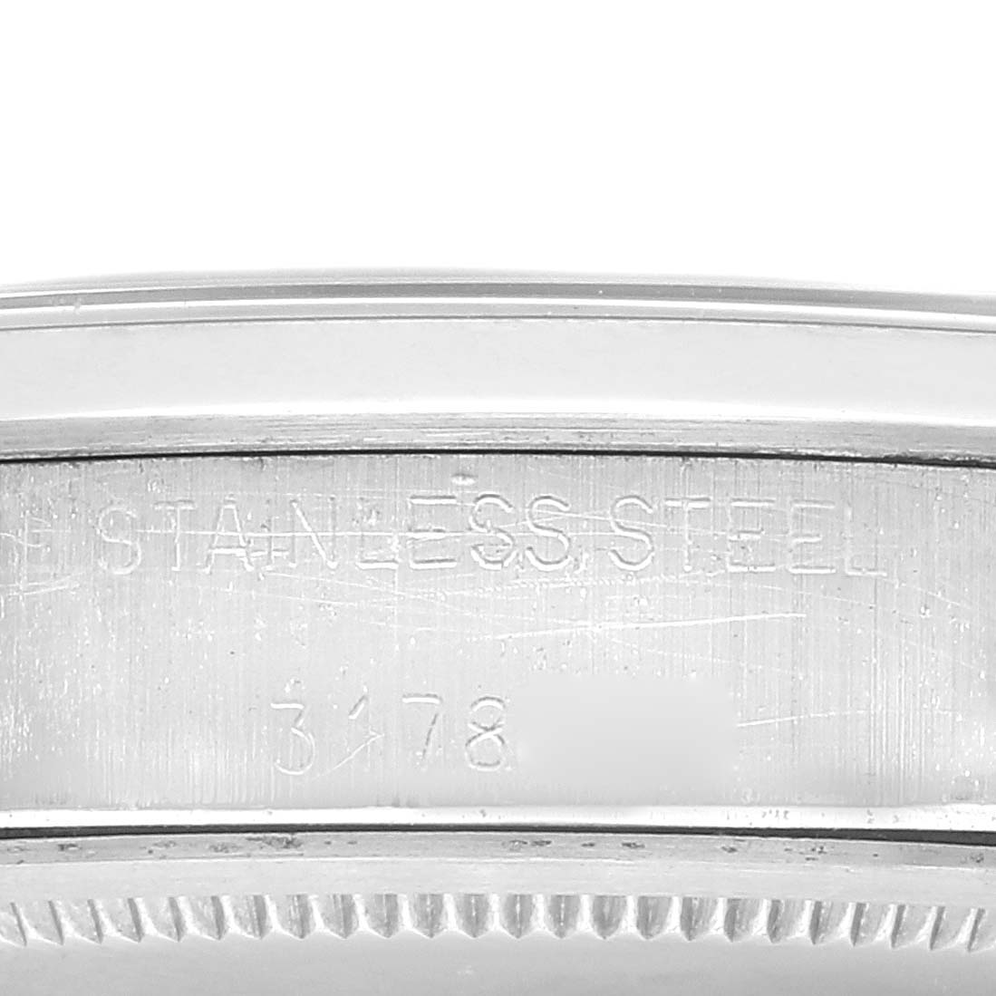 This image shows a close-up of the side case of a Rolex Vintage Collection 6694 Men
s Stainless Steel Silver Dial 6694 Men
s Stainless Steel Silver Dial watch, highlighting the "STAINLESS STEEL" engraving.