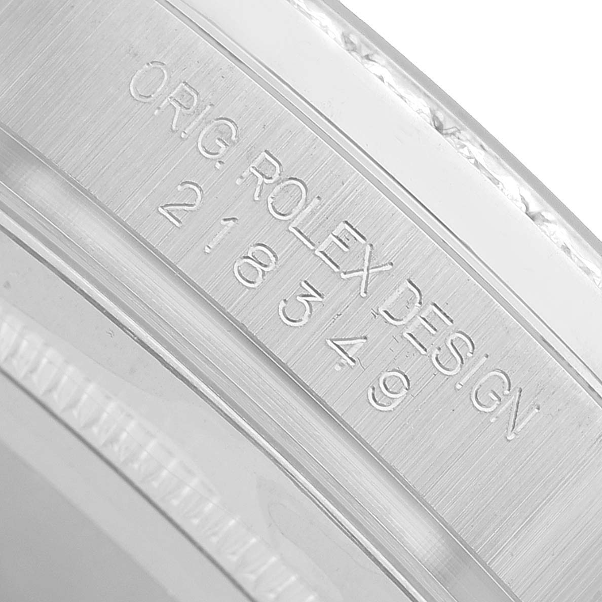 The image shows a close-up of the engraved inner bezel of a Rolex President 218349 Men's White Gold White Dial watch.