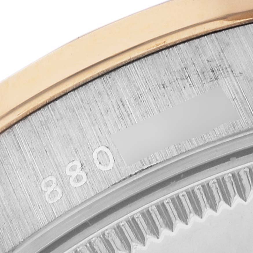 This is a close-up of the bezel and the inner ring showing part of the serial number of a Rolex President 68149 Women's White Gold Champagne Dial 68149 Women's White Gold Champagne Dial watch.