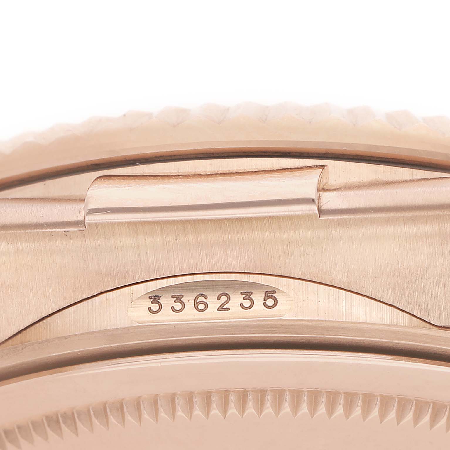 The image shows a close-up of the case side and bracelet interface of a Rolex Sky-Dweller 336235 Men's Rose Gold Brown Dial, revealing part of the serial number.