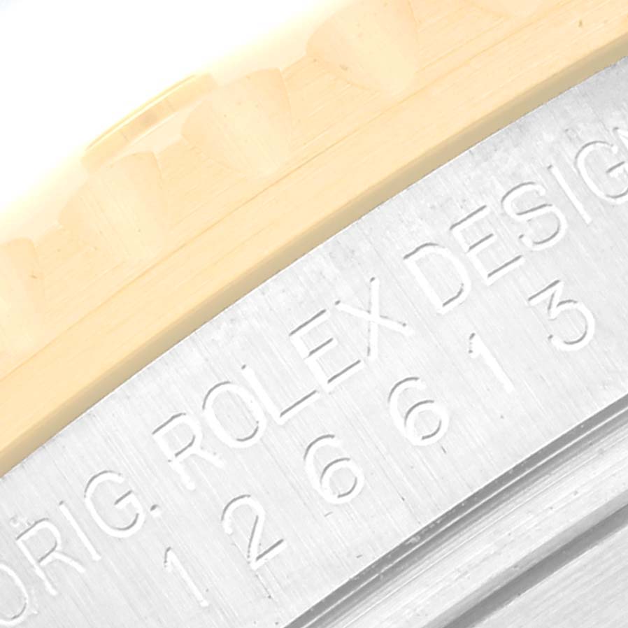 This close-up image shows the engraved case between the lugs of the Rolex Submariner 126613LB Men
s Steel and Gold (two tone) Blue Dial 126613LB Men
s Steel and Gold (two tone) Blue Dial watch.