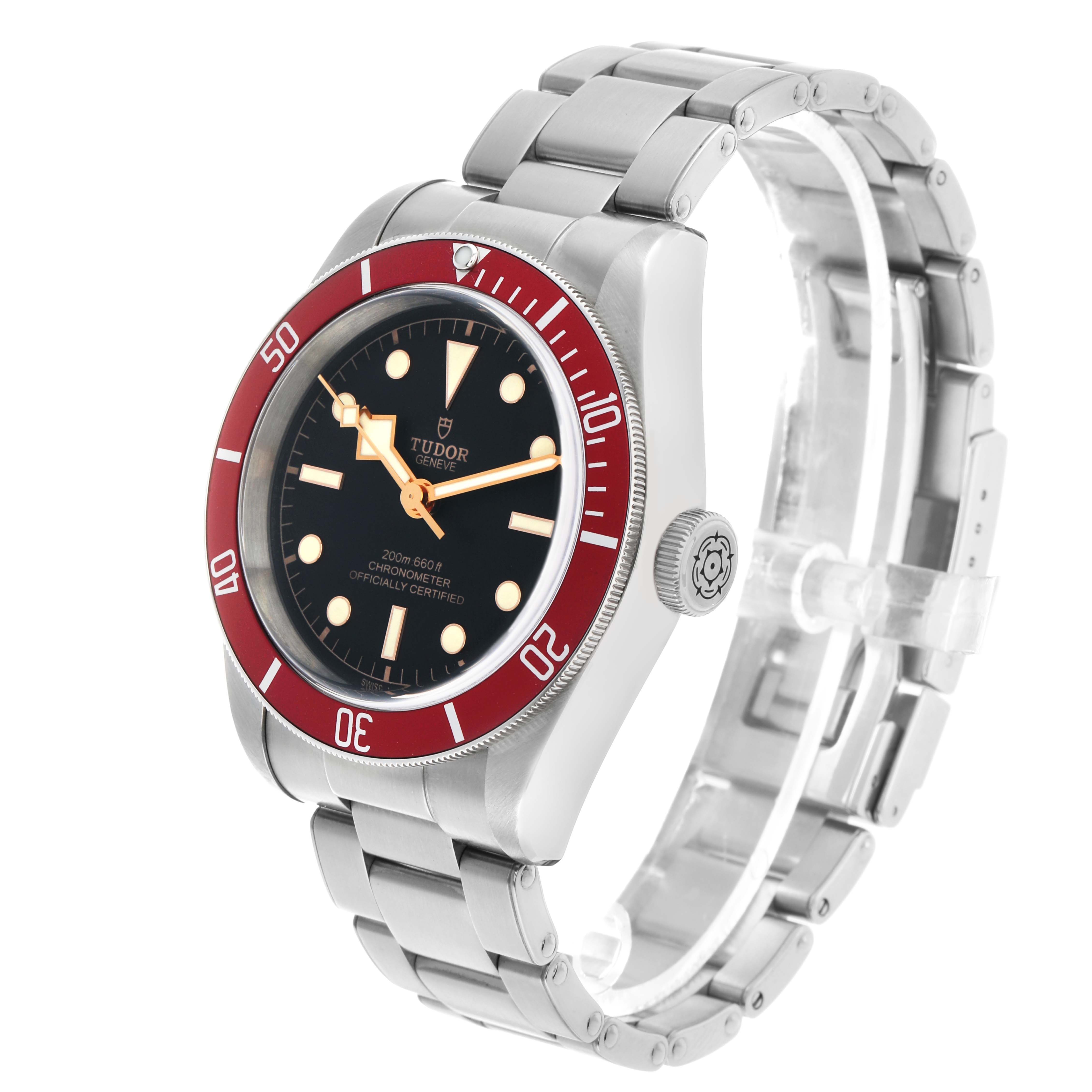 The Tudor Heritage Black Bay 79230R-0003 Men's Stainless Steel Black Dial watch is shown at a slight angle, highlighting the red bezel, dial, crown, and stainless steel bracelet.