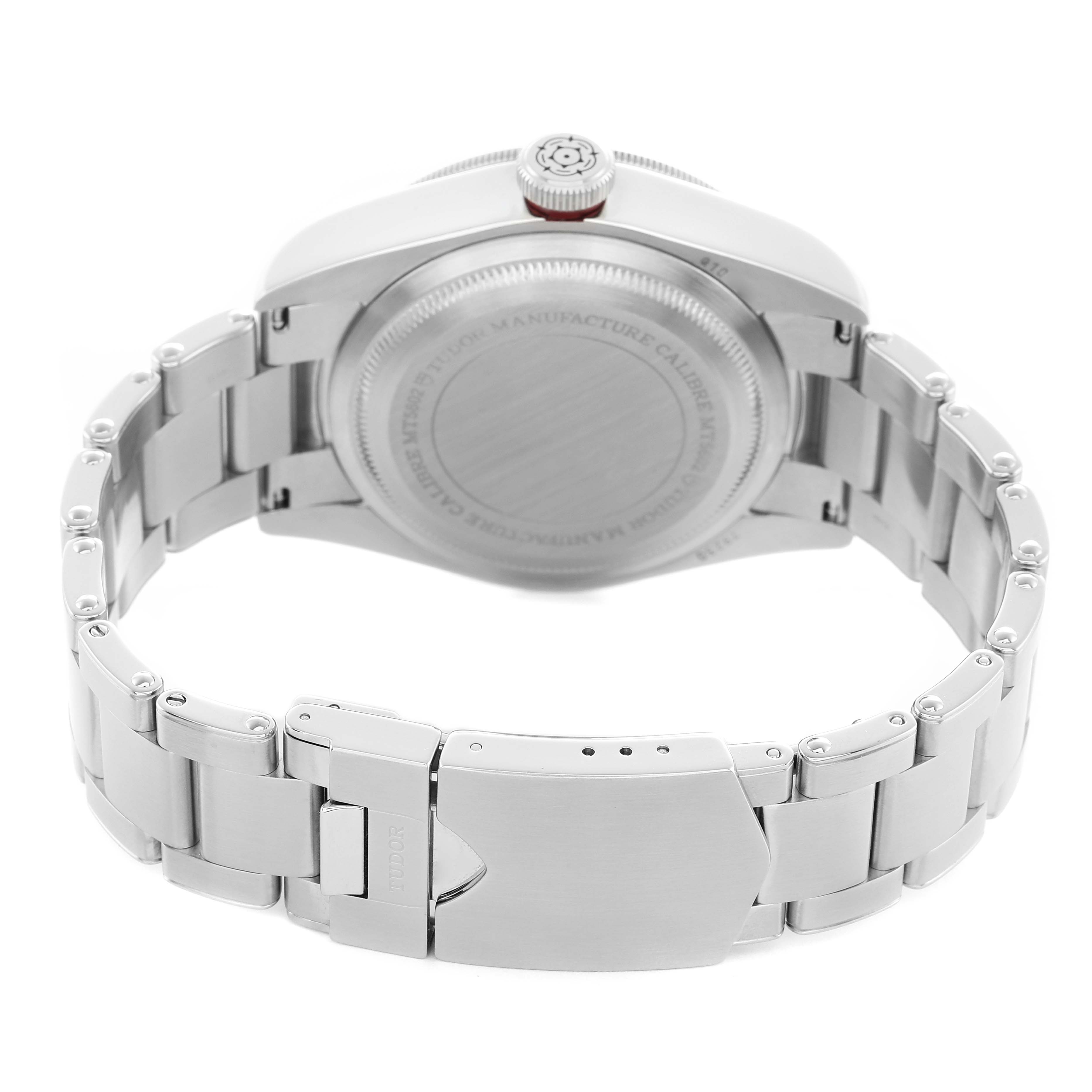 The image shows the underside of a Tudor Heritage Black Bay 79230R-0003 Men's Stainless Steel Black Dial watch, highlighting the case back and stainless steel bracelet with clasp.