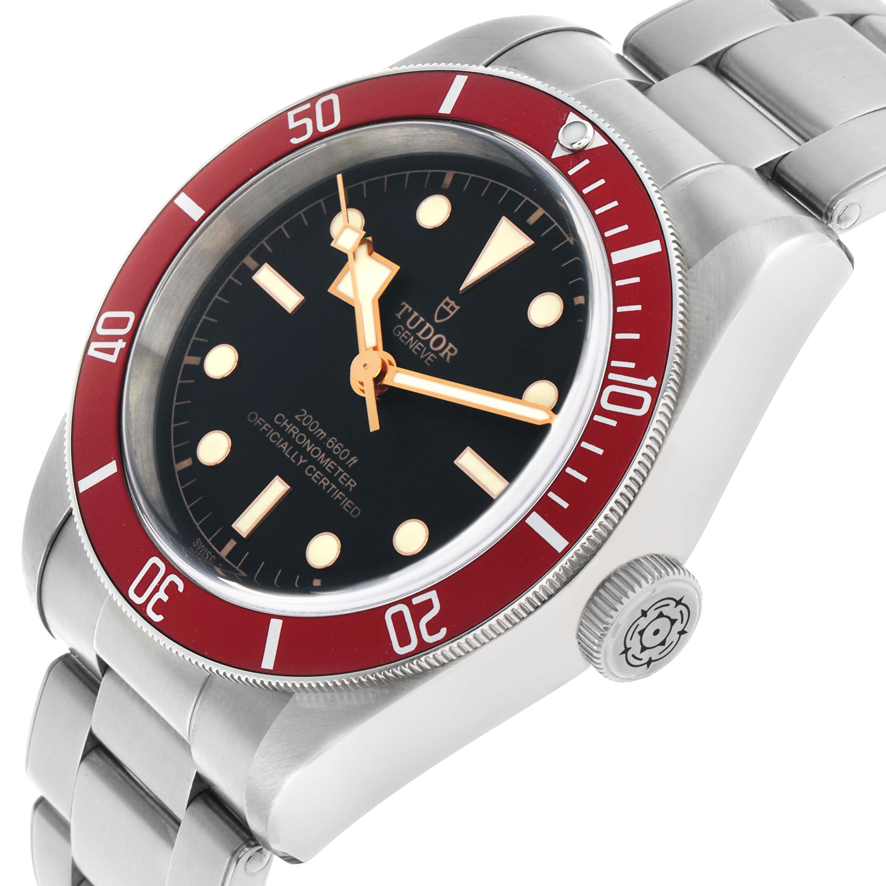 The Tudor Heritage Black Bay 79230R-0003 Men's Stainless Steel Black Dial watch is shown at an angle highlighting the dial, bezel, crown, and bracelet.