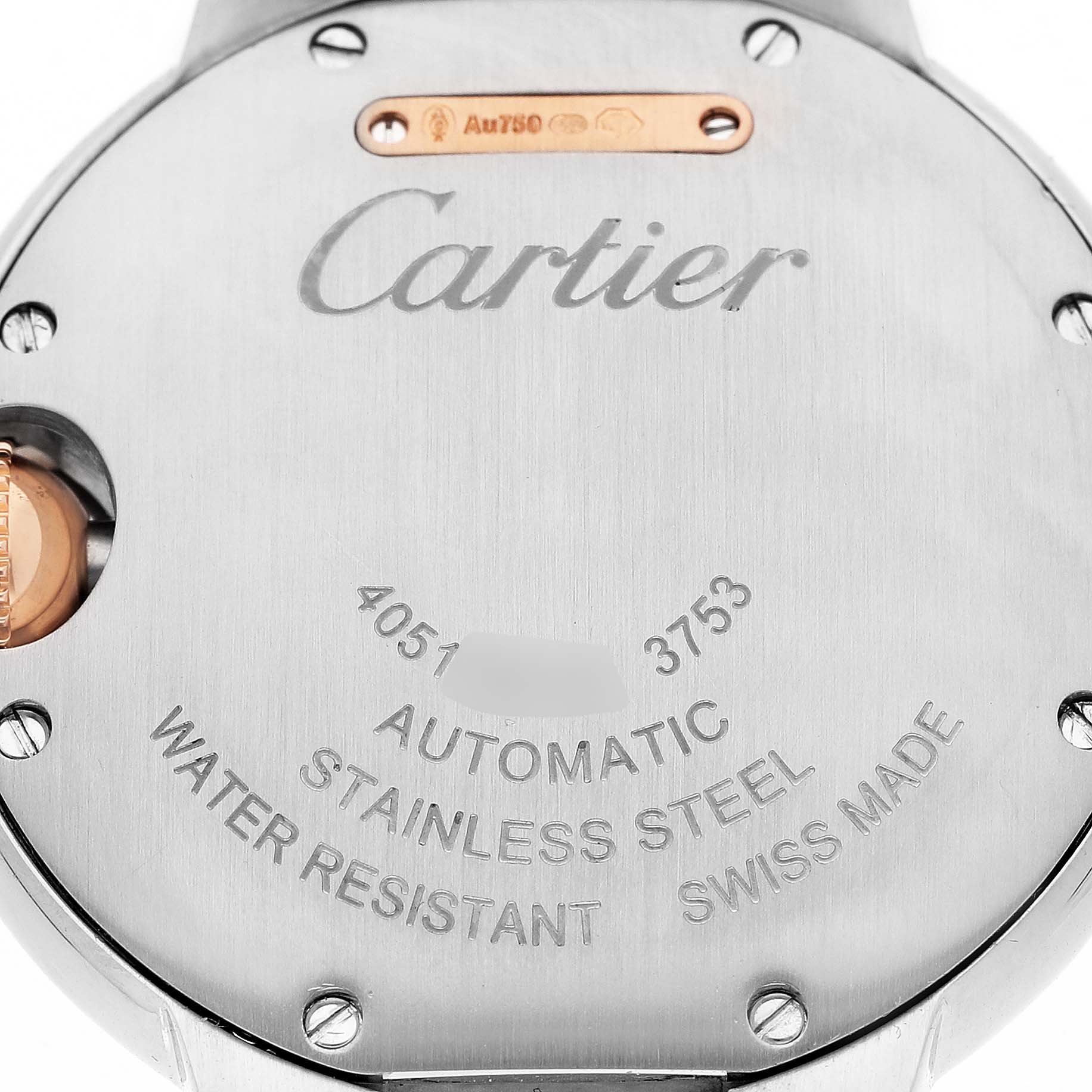 The image shows the case back of a Cartier Ballon Bleu WE902077 Women's Steel and Gold (two tone) Silver Dial watch, featuring engraved details and a partial view of the crown.