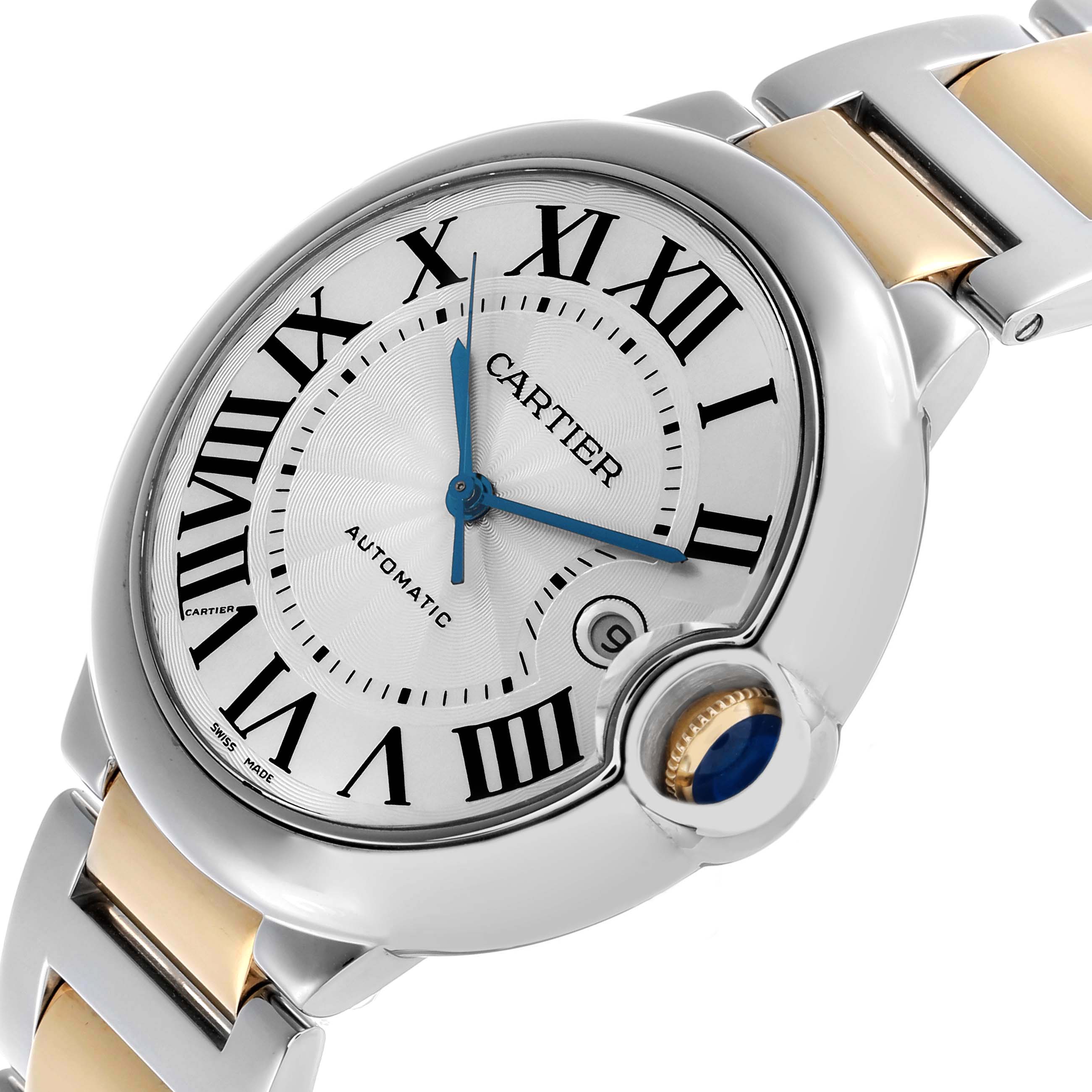 The Cartier Ballon Bleu W69009Z3 Men's Steel and Gold (two tone) Silver Dial watch is shown at an angled view, highlighting its silver case, blue hands, Roman numerals, and metal bracelet.