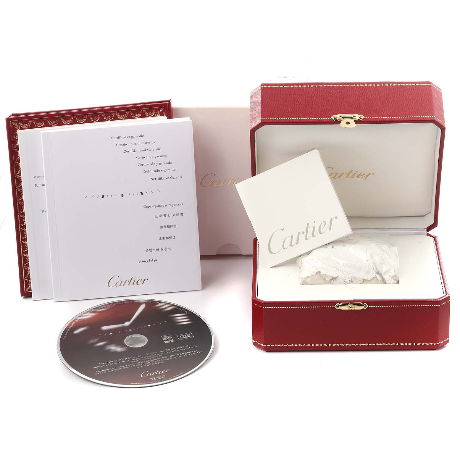 The image shows a Calibre de Cartier box, manual, certificate, and a DVD at a slight angle.