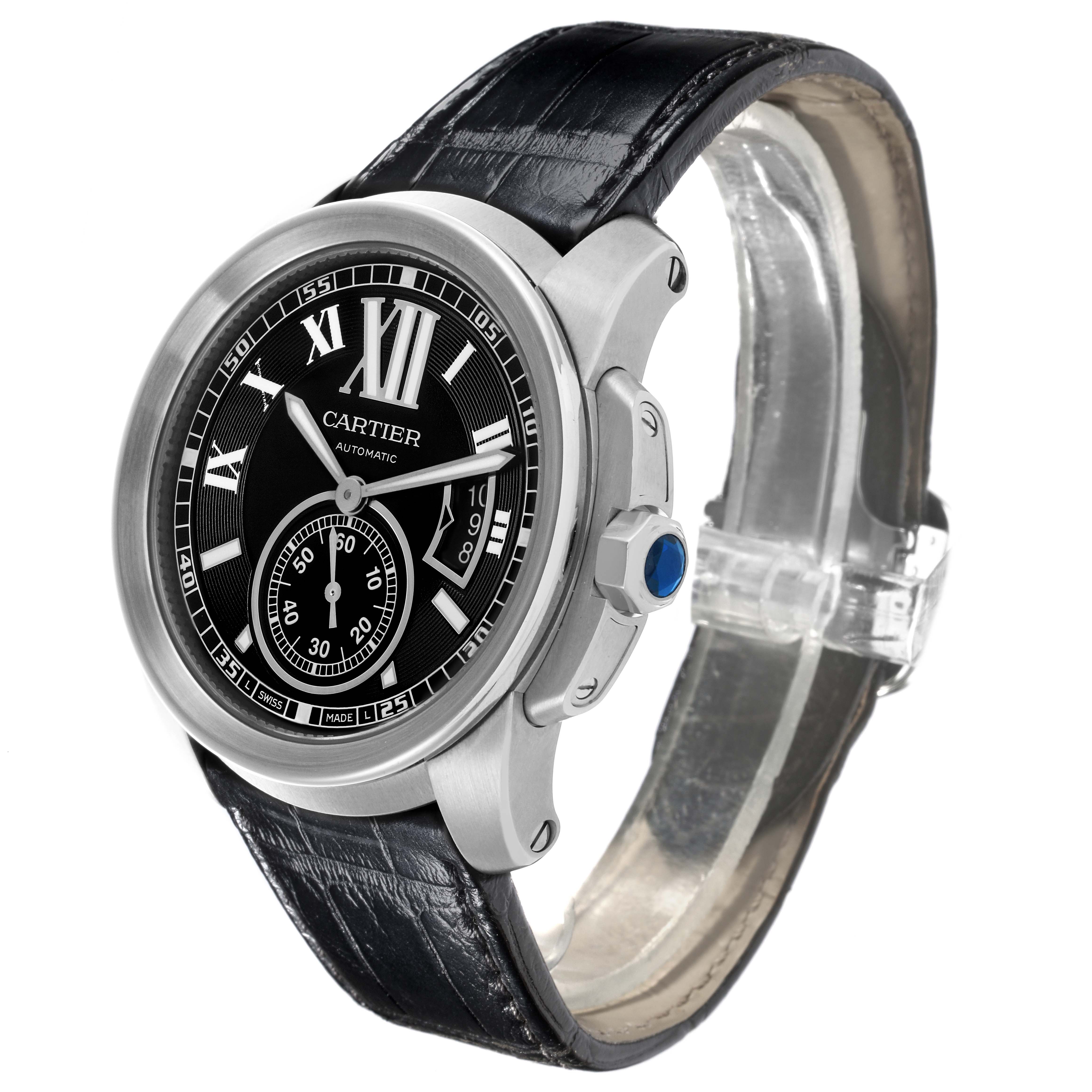 The Calibre de Cartier watch is shown at a three-quarter angle, highlighting the dial, crown, and leather strap.
