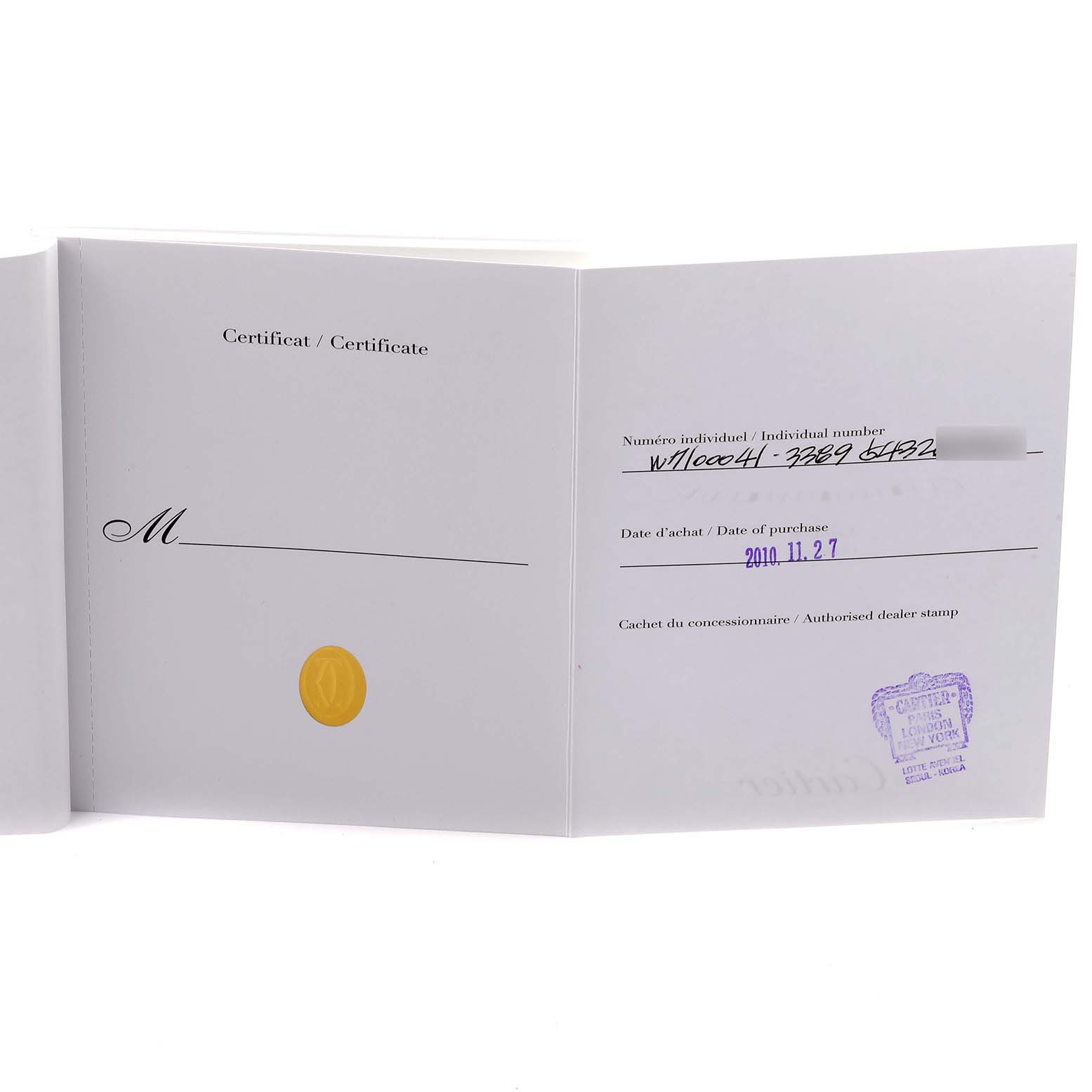 The image shows a certificate booklet for the Calibre de Cartier watch by Cartier, viewed open with stamp and handwritten details visible.