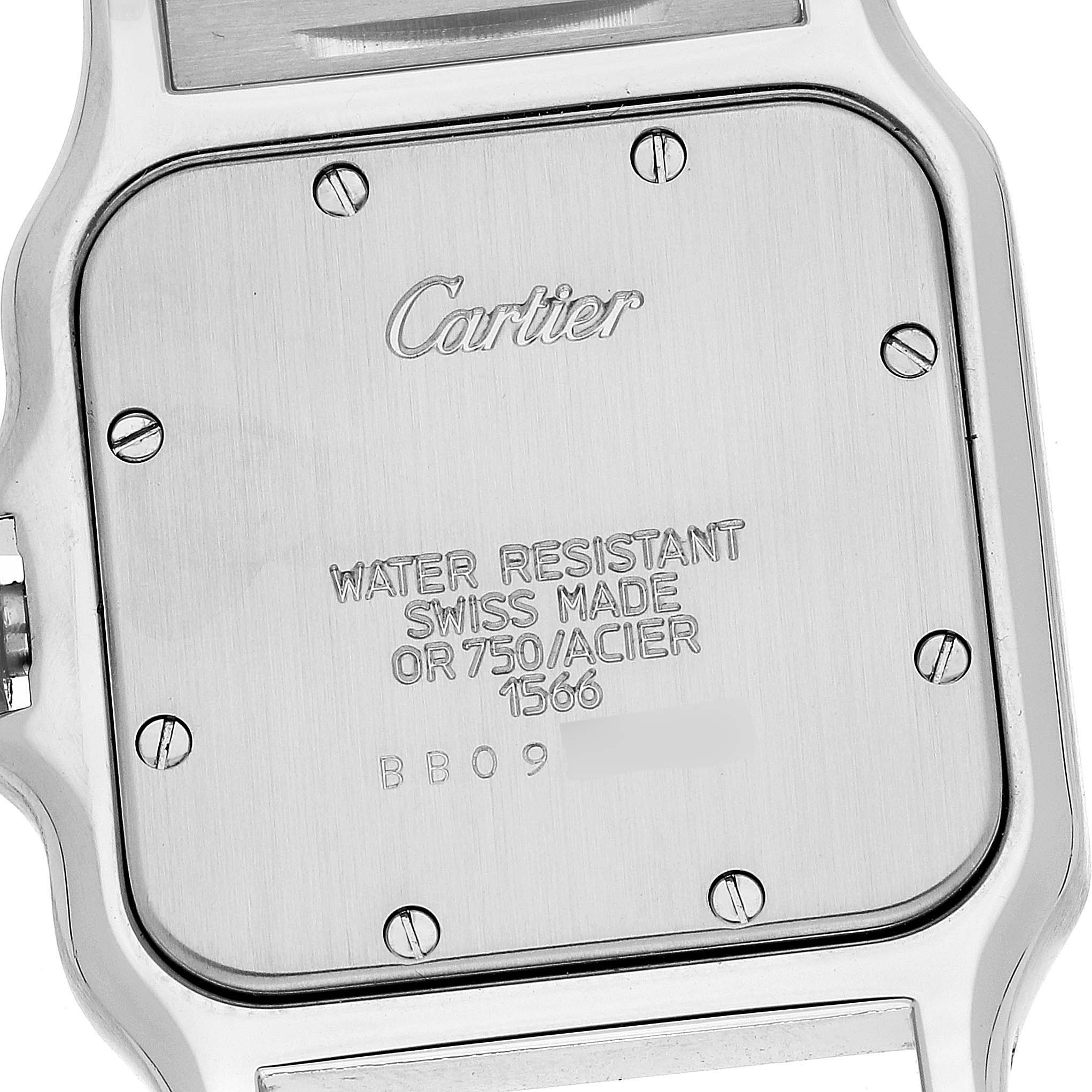 The image shows the back case of the Cartier Santos W20011C4 Men
s Steel and Gold (two tone) Silver Dial W20011C4 Men
s Steel and Gold (two tone) Silver Dial watch, displaying its screws, engravings, and branding.