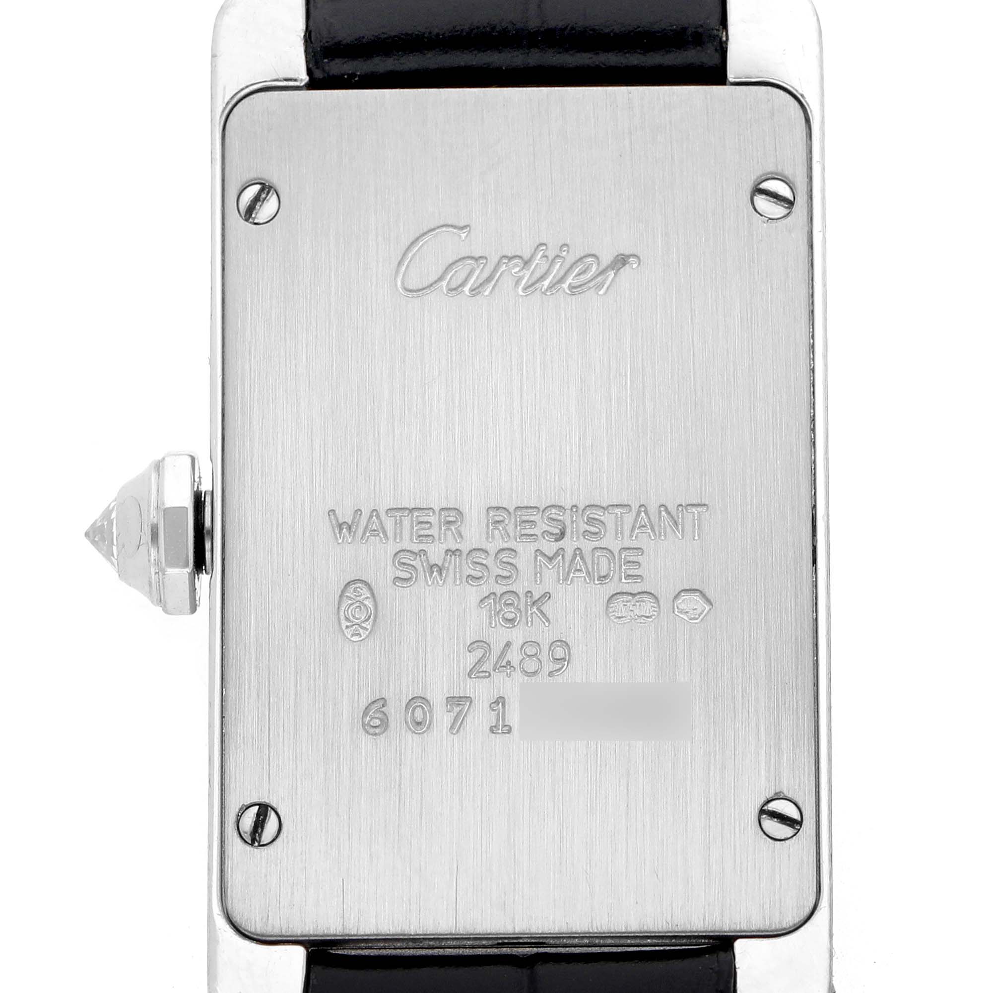The image shows the back case of a Cartier Tank Americaine WB705131 Women's White Gold Grey Dial watch, featuring its inscriptions and crown.