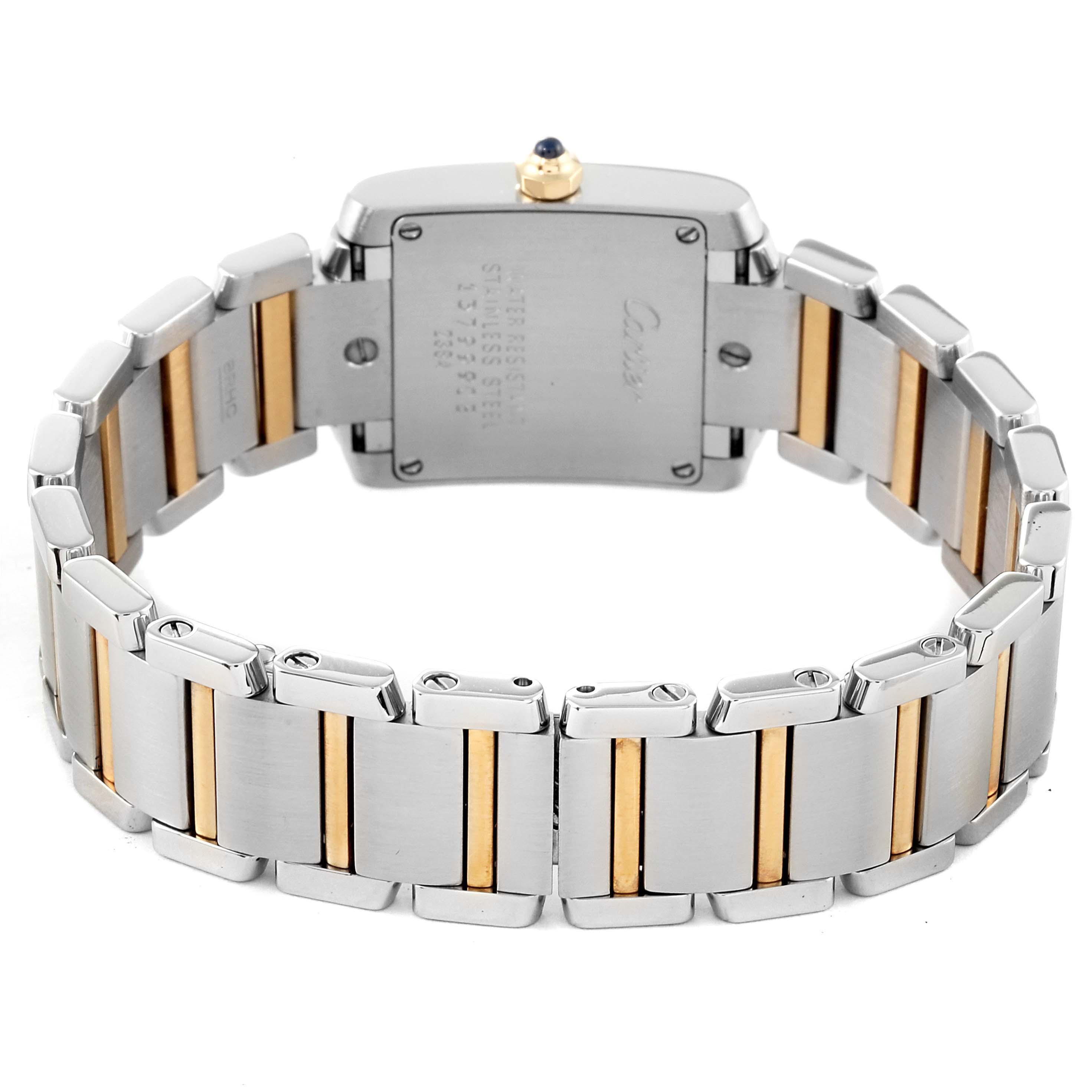 The image shows the back of a Cartier Tank Française watch, highlighting its stainless steel and gold bracelet.