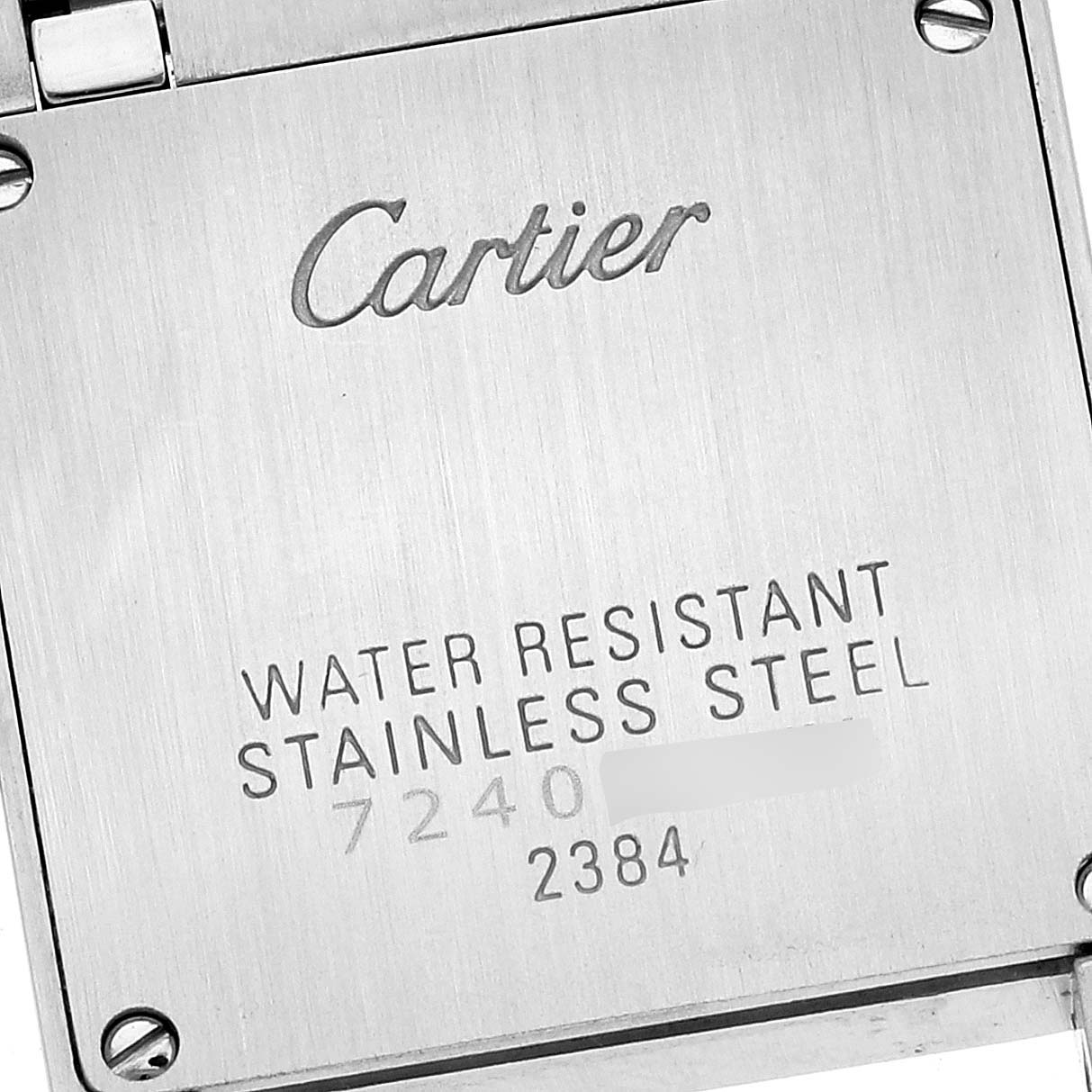 The image shows a close-up of the back of a Cartier Tank Francaise W51007Q4 Women
s Steel and Gold (two tone) Silver Dial W51007Q4 Women
s Steel and Gold (two tone) Silver Dial watch, highlighting its water resistance and stainless steel details.