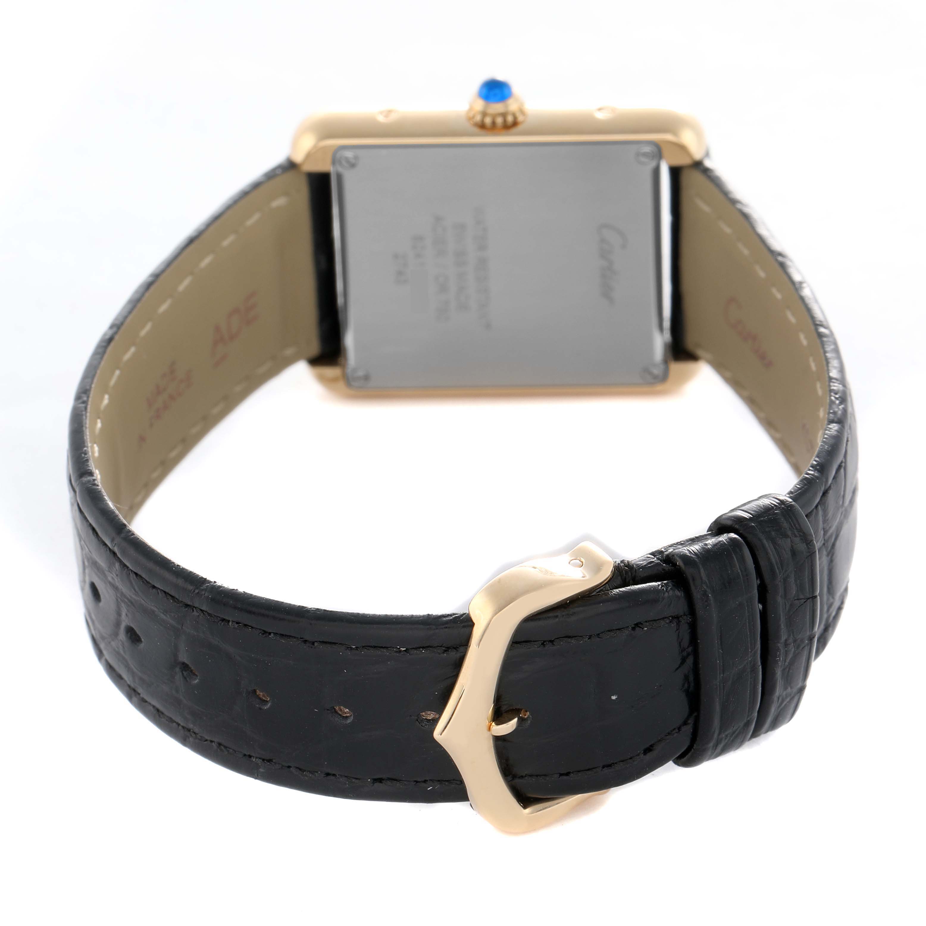 The Cartier Tank Solo W1018755 Women's Yellow Gold Silver Dial watch is shown from the back, displaying the case, crown, and black leather strap with a gold buckle.