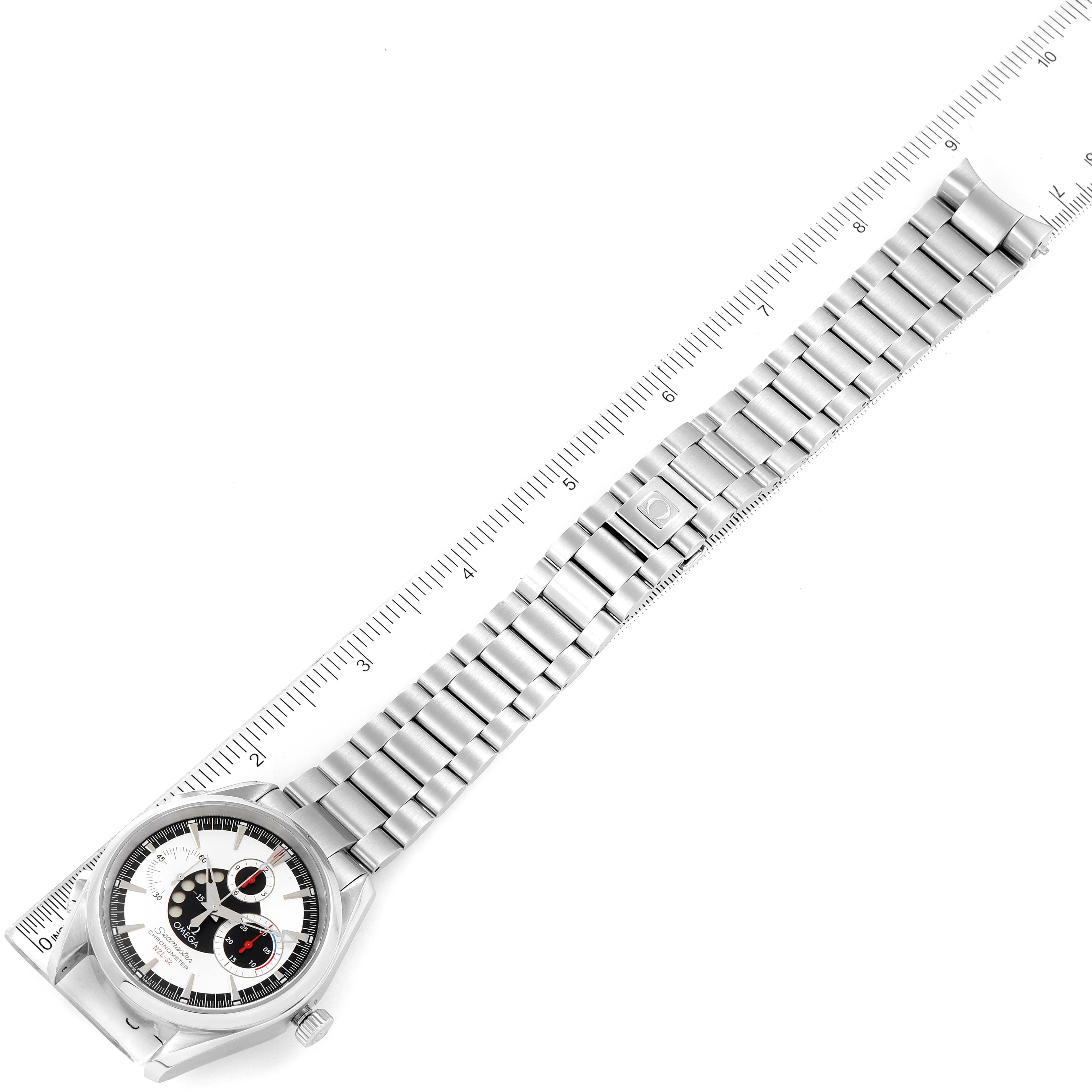 The image shows an Omega Aqua Terra 2513.30.00 Men
s Stainless Steel Silver Dial 2513.30.00 Men
s Stainless Steel Silver Dial watch, laid flat, emphasizing the face and metal bracelet alongside a ruler.