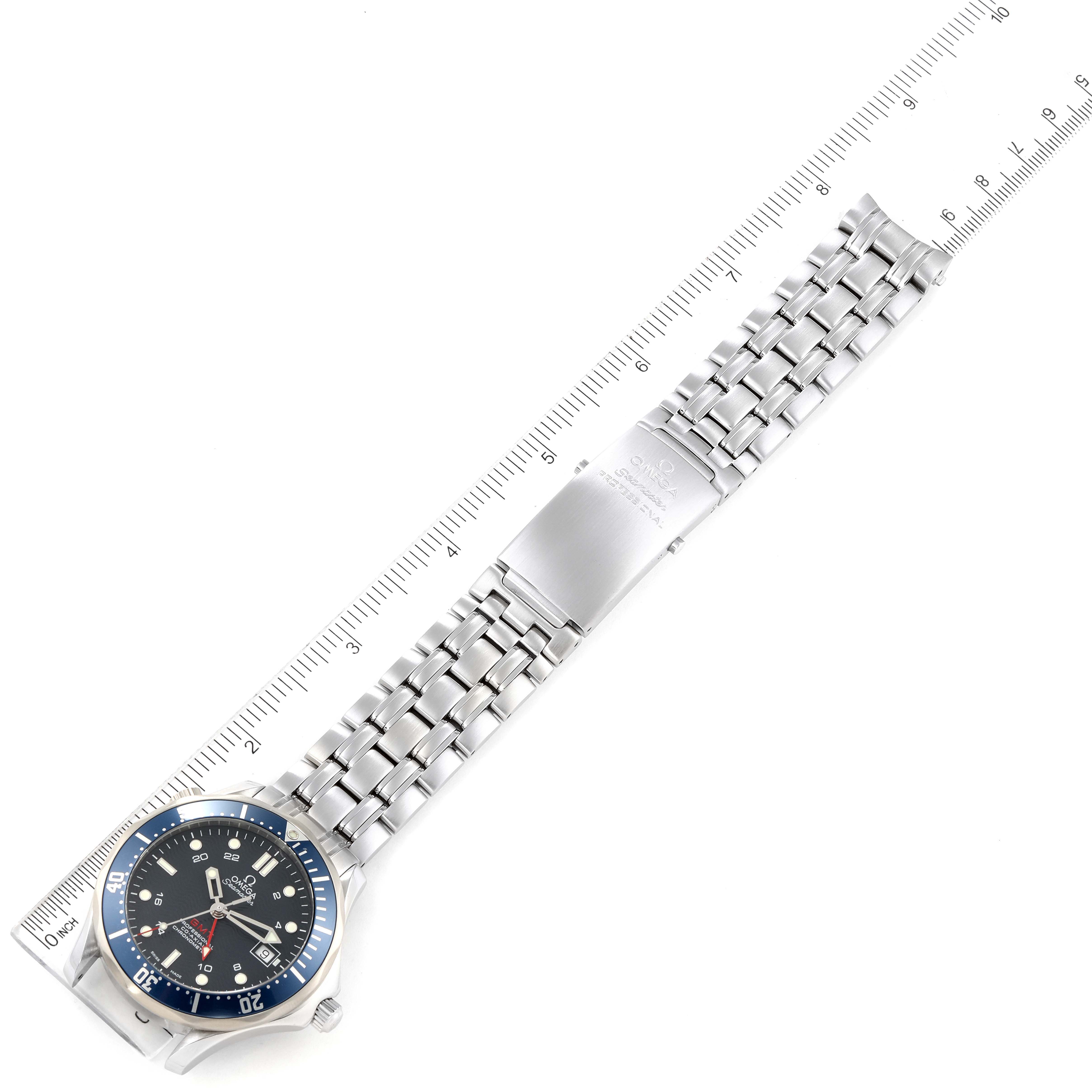 The image shows an Omega Seamaster 2535.80.00 Men's Stainless Steel Blue Dial 2535.80.00 Men's Stainless Steel Blue Dial watch fully extended with a metal bracelet, laid next to a ruler for measurement.