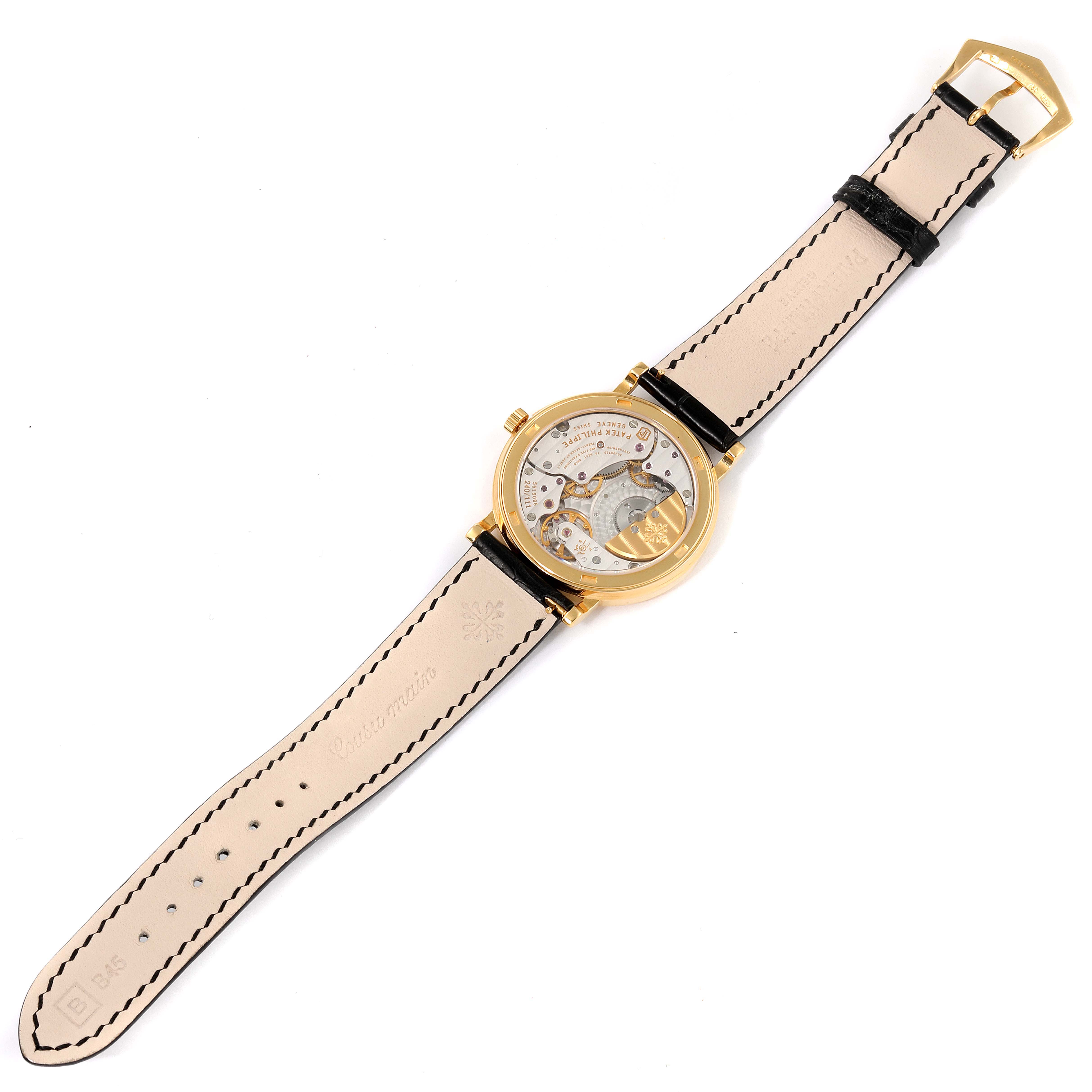 The image shows the back view of a Patek Philippe Calatrava 5120J Men
s Yellow Gold White Dial 5120J Men
s Yellow Gold White Dial watch, displaying the movement and leather strap.