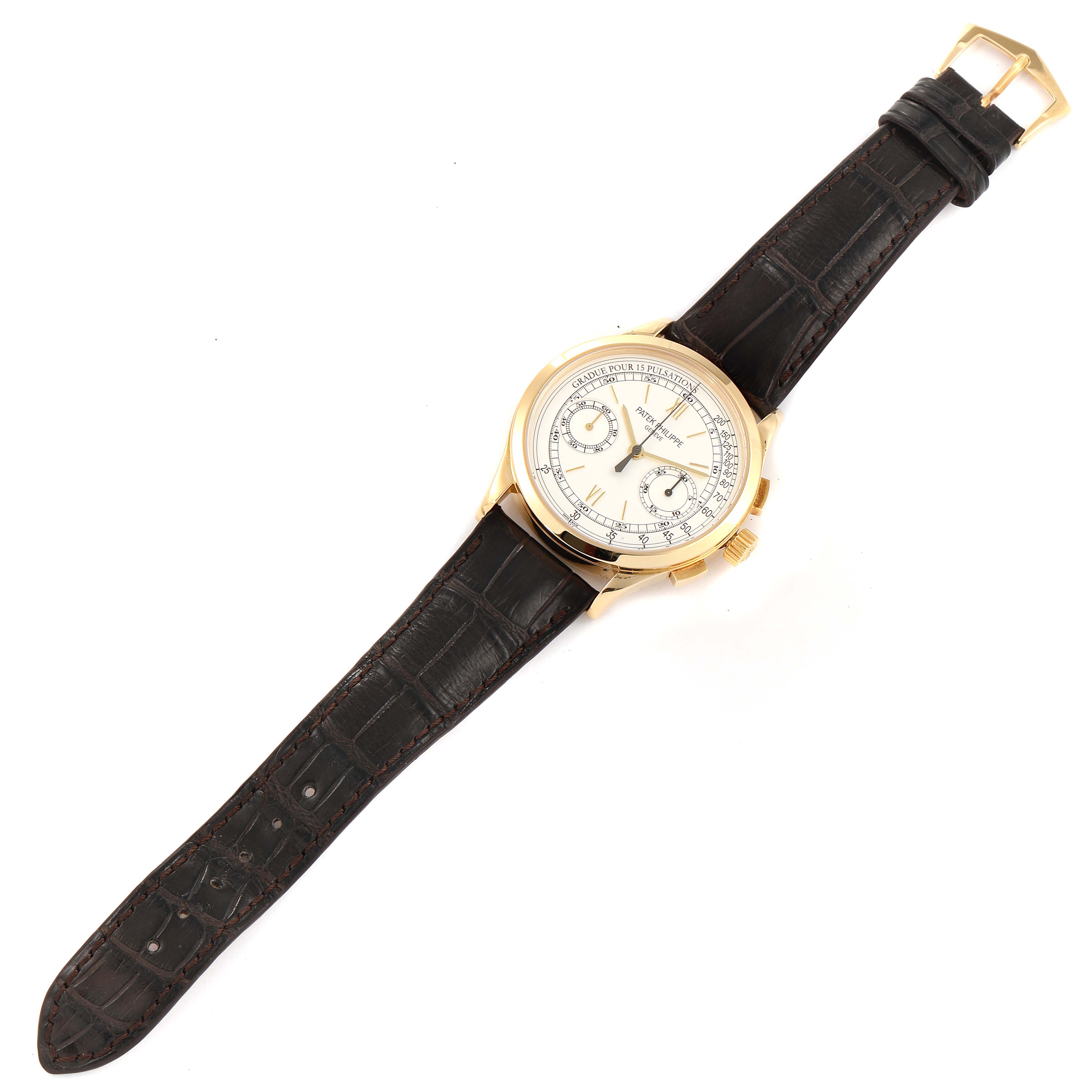 The image shows a Patek Philippe Complications 5170J Men's Yellow Gold Silver Dial 5170J Men's Yellow Gold Silver Dial model watch from a top-down angle, featuring the face, leather strap, and buckle.