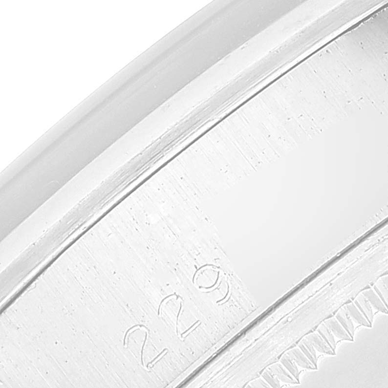 This is a close-up of the case side and bezel of the Rolex Date 1500 Men
s Stainless Steel Silver Dial 1500 Men
s Stainless Steel Silver Dial model, showing engraved details.