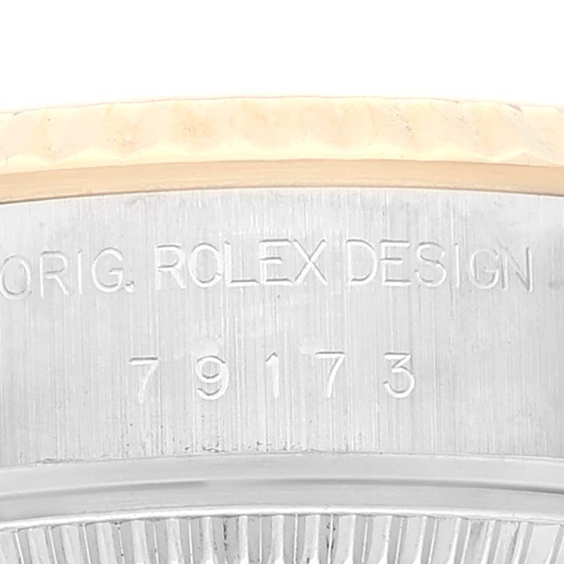 This image shows a close-up of the Rolex Datejust 79173 Women's Steel and Gold (two tone) White Dial 79173 Women's Steel and Gold (two tone) White Dial model 79173, focusing on the engraved outer casing near the bezel.