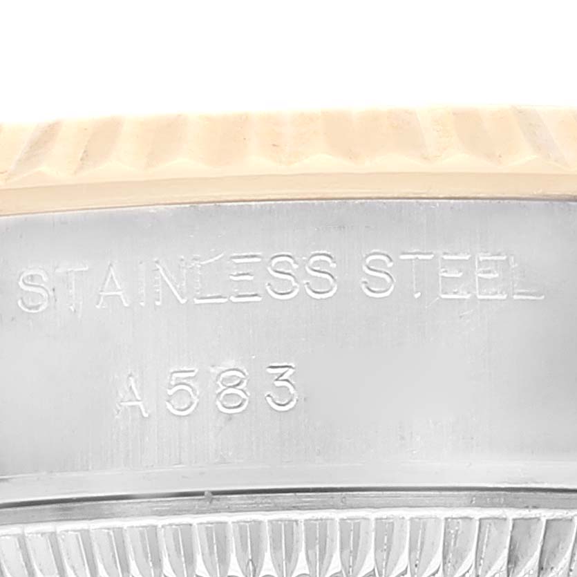 The image shows a close-up of the stainless steel band with the inscription "A583" and the fluted bezel of the Rolex Datejust 79173 Women's Steel and Gold (two tone) White Dial 79173 Women's Steel and Gold (two tone) White Dial.
