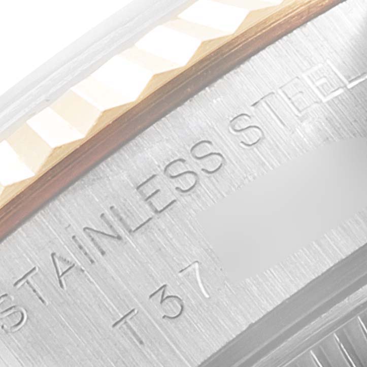 This close-up angle shows the side of a Rolex Datejust 69173 Women
s Steel and Gold (two tone) Champagne Dial 69173 Women
s Steel and Gold (two tone) Champagne Dial watch, highlighting the stainless steel and part of the engraved text.