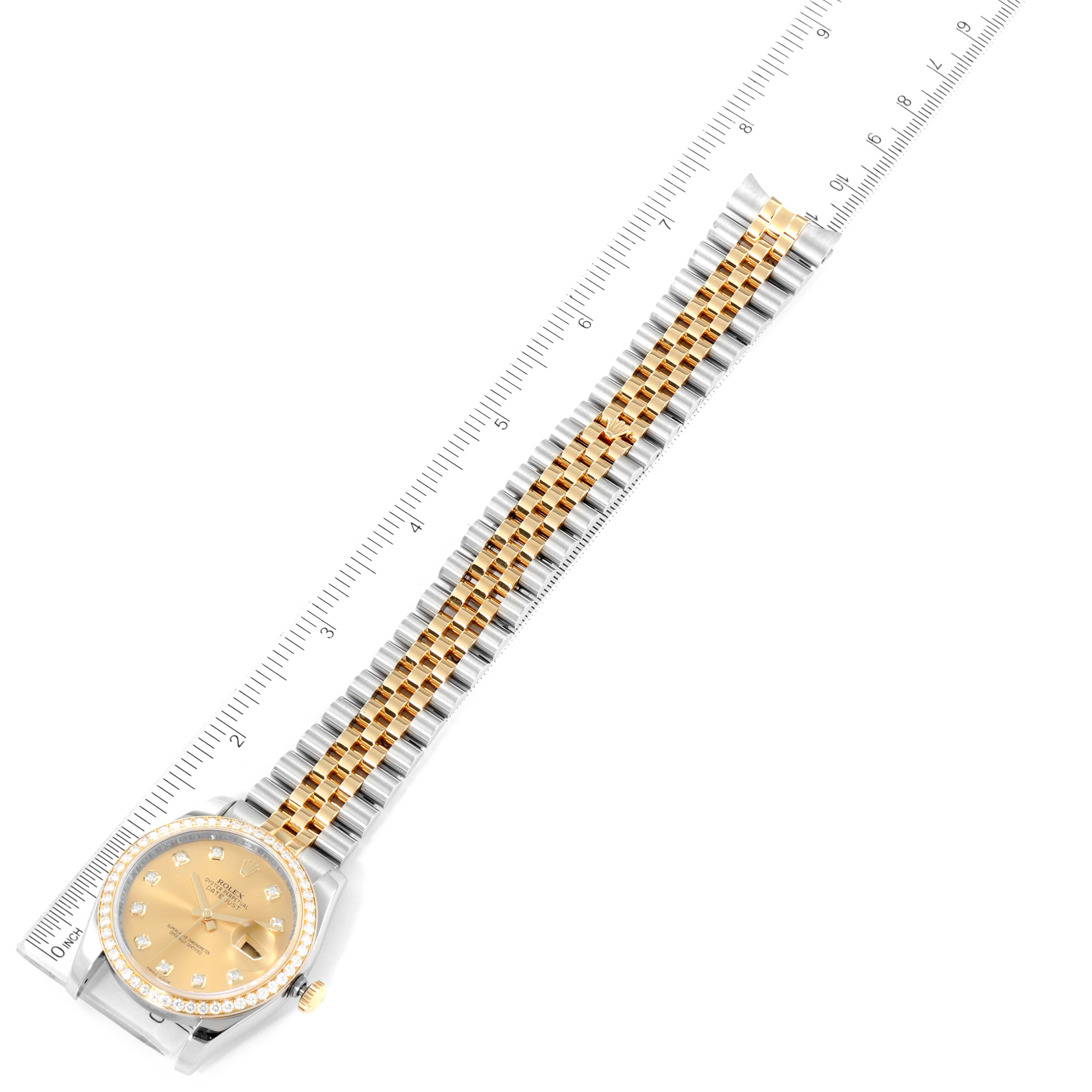 The image shows a full view of a Rolex Datejust 116243 Men
s Steel and Gold (two tone) Champagne Dial 116243 Men
s Steel and Gold (two tone) Champagne Dial watch with a two-tone bracelet next to a ruler for scale.
