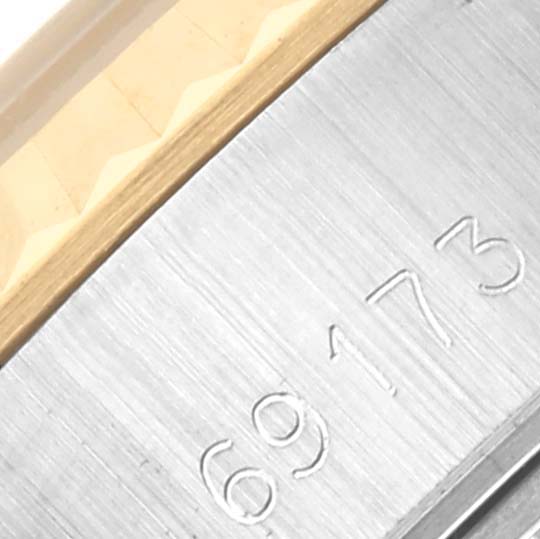 The image shows a close-up of the Rolex Datejust 69173 Women's Steel and Gold (two tone) Beige Dial 69173 Women's Steel and Gold (two tone) Beige Dial watch's case side, highlighting the engraved serial number.