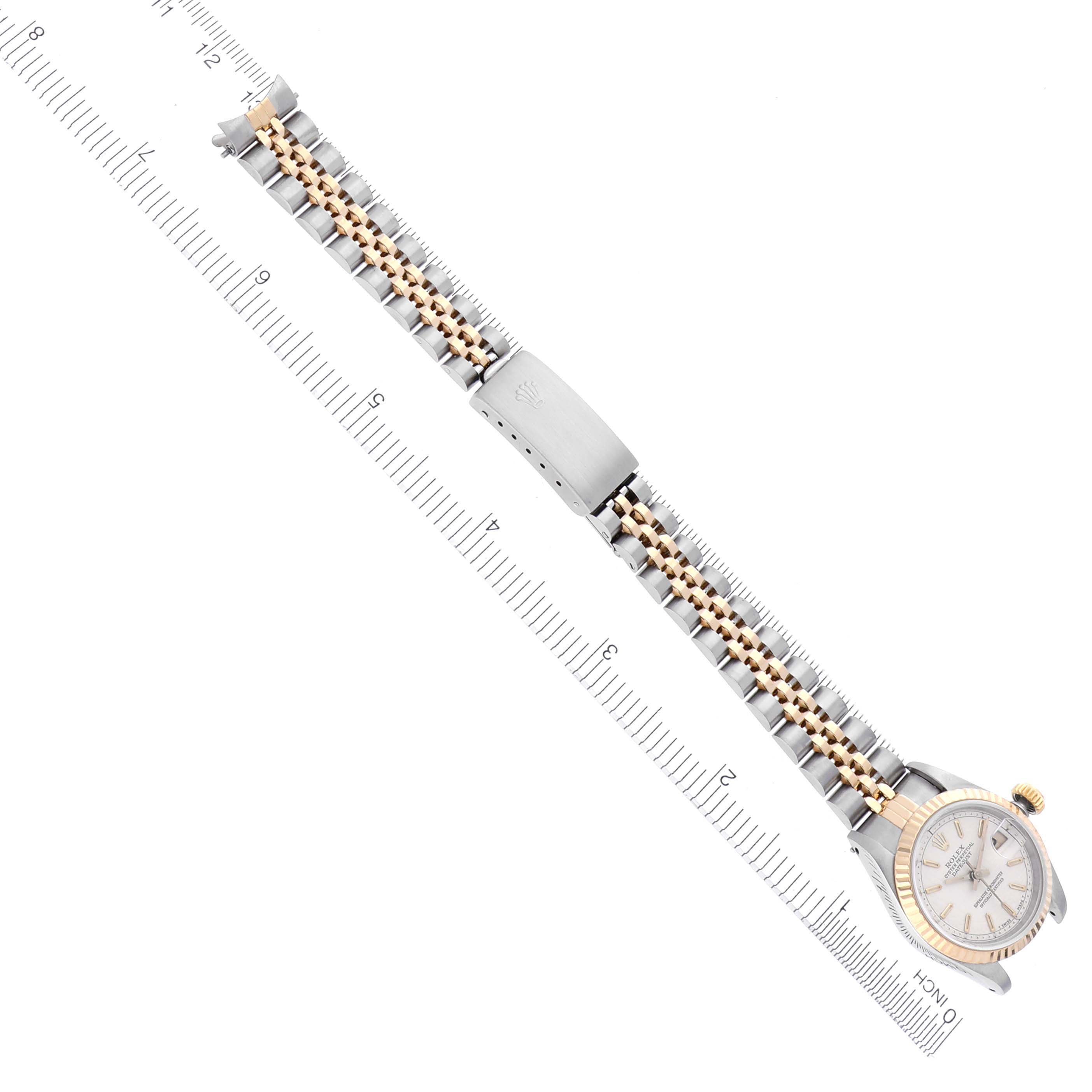 The Rolex Datejust 69173 Women's Steel and Gold (two tone) Beige Dial 69173 Women's Steel and Gold (two tone) Beige Dial watch is shown from an angled top view, highlighting the bracelet and clasp along a ruler for scale.