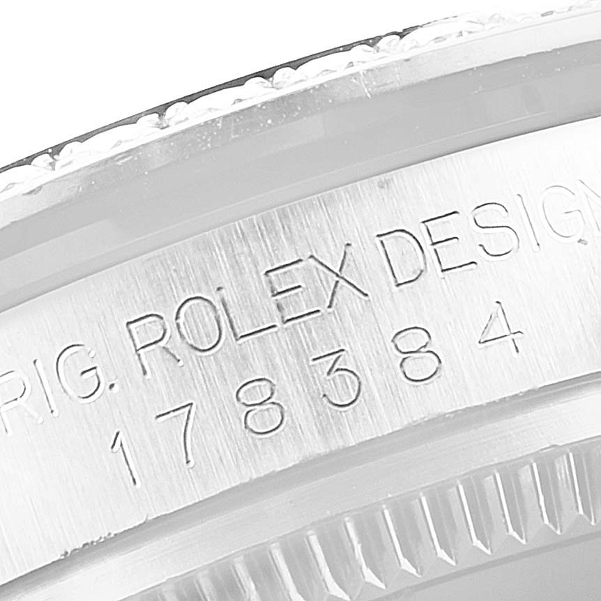 Close-up of the side of a Mid-Size Rolex watch, displaying the model number and "ROLEX DESIGN" engraving.