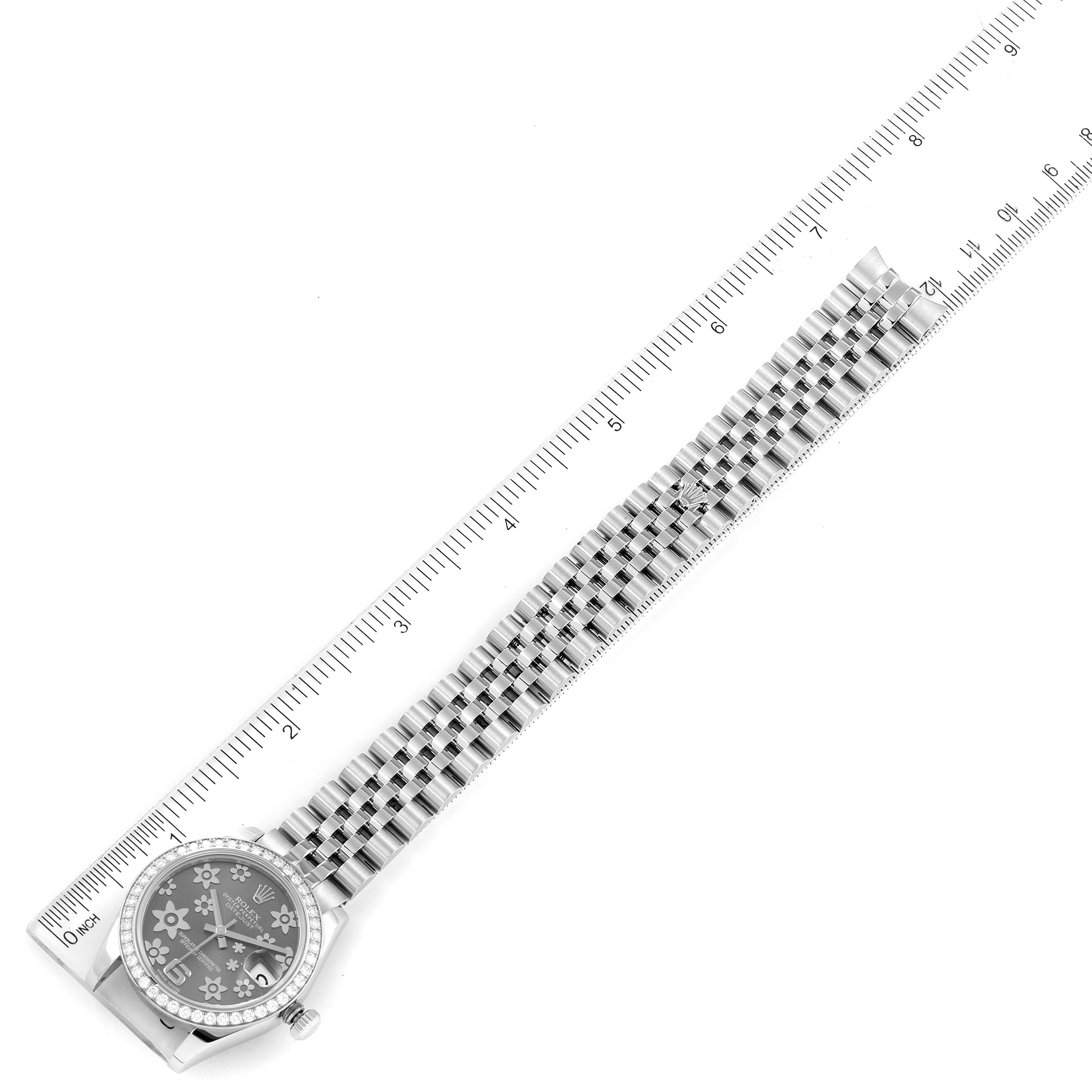 The image shows a top-down view of a Mid-Size Rolex watch, with the entire watch and a ruler for scale.