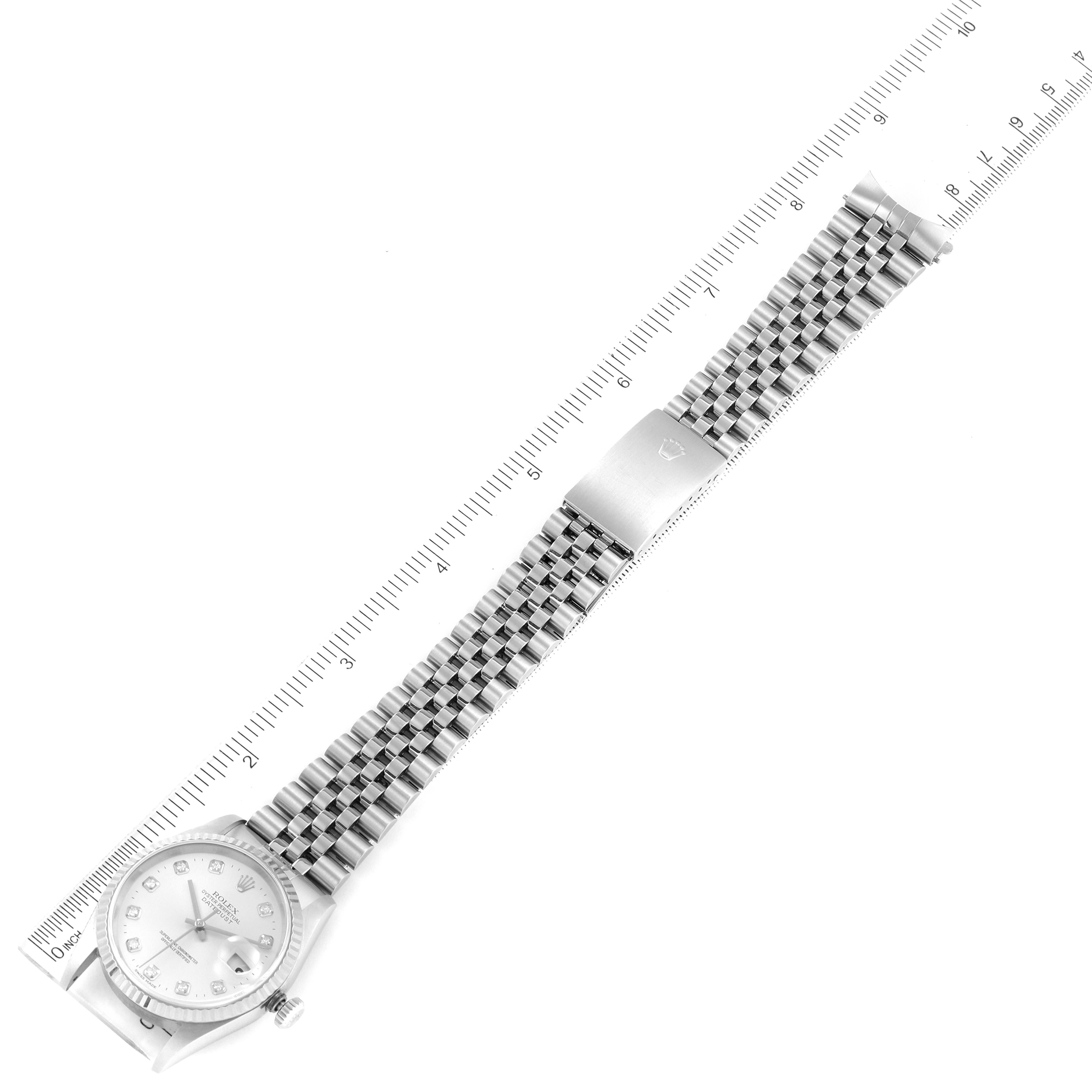 The image shows a Rolex Datejust 16234 Men's Stainless Steel Silver Dial 16234 Men's Stainless Steel Silver Dial model watch lying flat, displaying its face, entire bracelet, and clasp alongside a ruler.