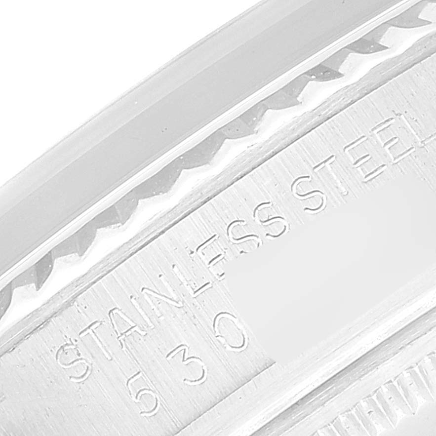 This image shows a close-up of the serial number and "STAINLESS STEEL" engraving on the Rolex Datejust 16014 Men's Stainless Steel Silver Dial 16014 Men's Stainless Steel Silver Dial watch case.
