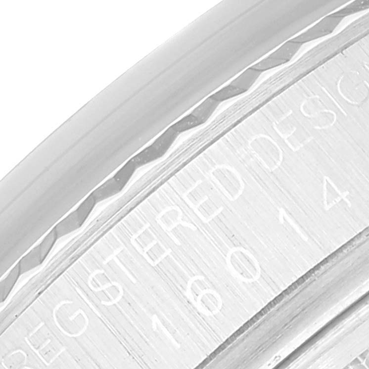 This is a close-up view of the rehaut and bezel of the Rolex Datejust 16014 Men's Stainless Steel Silver Dial 16014 Men's Stainless Steel Silver Dial watch, showing engraved text and model number.