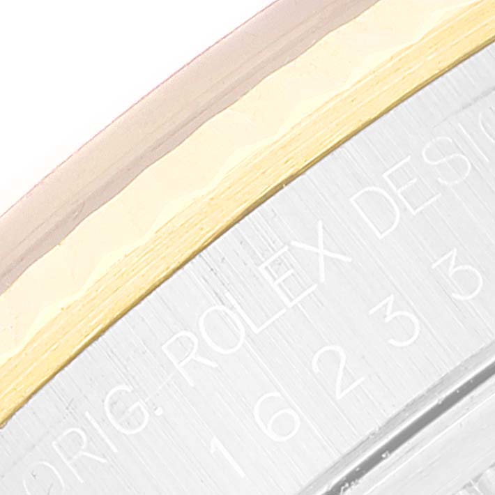 The image shows a close-up of the engraved bezel on a Rolex Datejust 16233 Men's Steel and Gold (two tone) Blue Dial 16233 Men's Steel and Gold (two tone) Blue Dial watch.