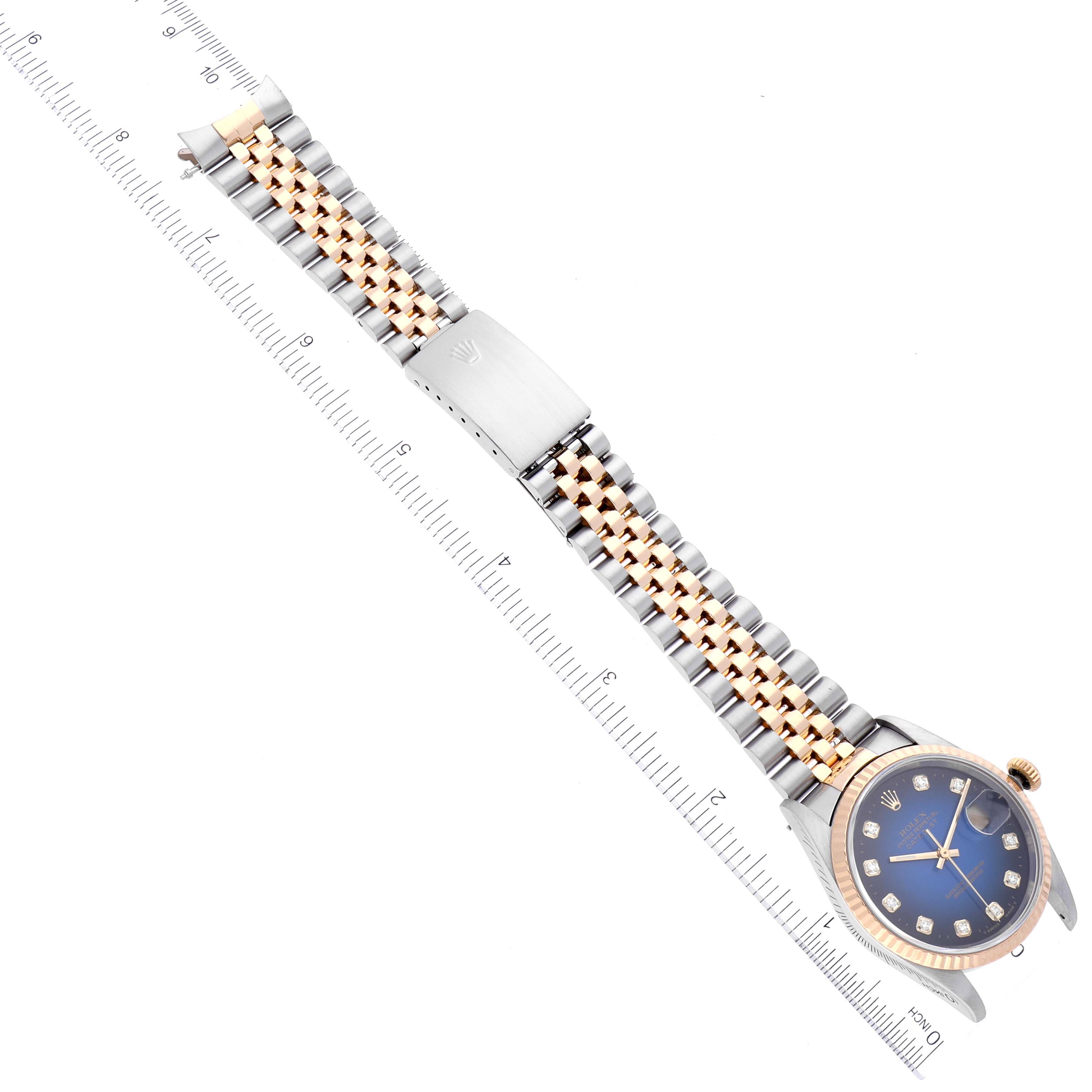 This image shows a top-down view of a Rolex Datejust 16233 Men's Steel and Gold (two tone) Blue Dial 16233 Men's Steel and Gold (two tone) Blue Dial watch, highlighting its jubilee bracelet and blue dial with diamond hour markers.
