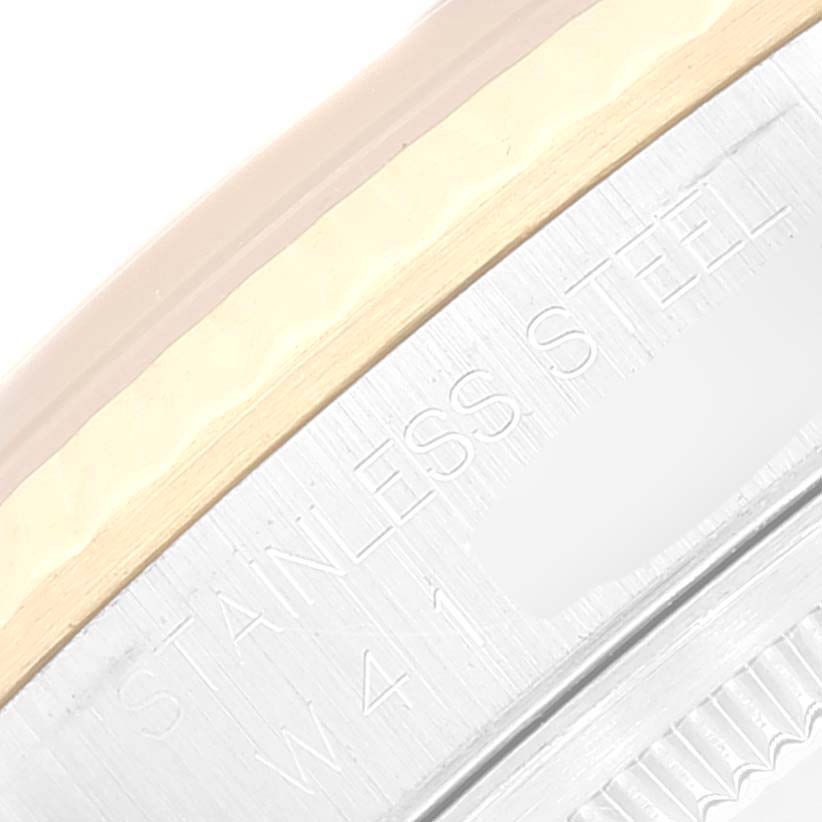 This is a close-up of the engraved part of a Rolex Datejust 16233 Men's Steel and Gold (two tone) Blue Dial 16233 Men's Steel and Gold (two tone) Blue Dial watch, showing "STAINLESS STEEL" and a portion of the bezel.