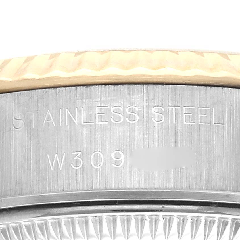 The image shows a close-up of the stainless steel side case of a Rolex Datejust 69173 Women's Steel and Gold (two tone) Champagne Dial 69173 Women's Steel and Gold (two tone) Champagne Dial watch with engraved text.