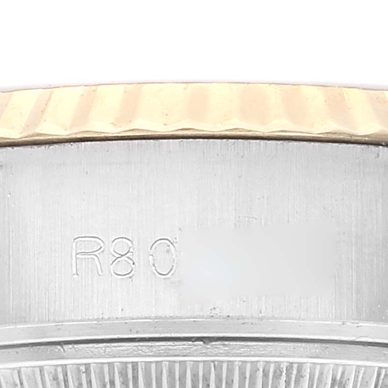 This close-up image shows the side engraving and part of the bezel of a Rolex Datejust 69173 Women's Steel and Gold (two tone) Champagne Dial 69173 Women's Steel and Gold (two tone) Champagne Dial watch.