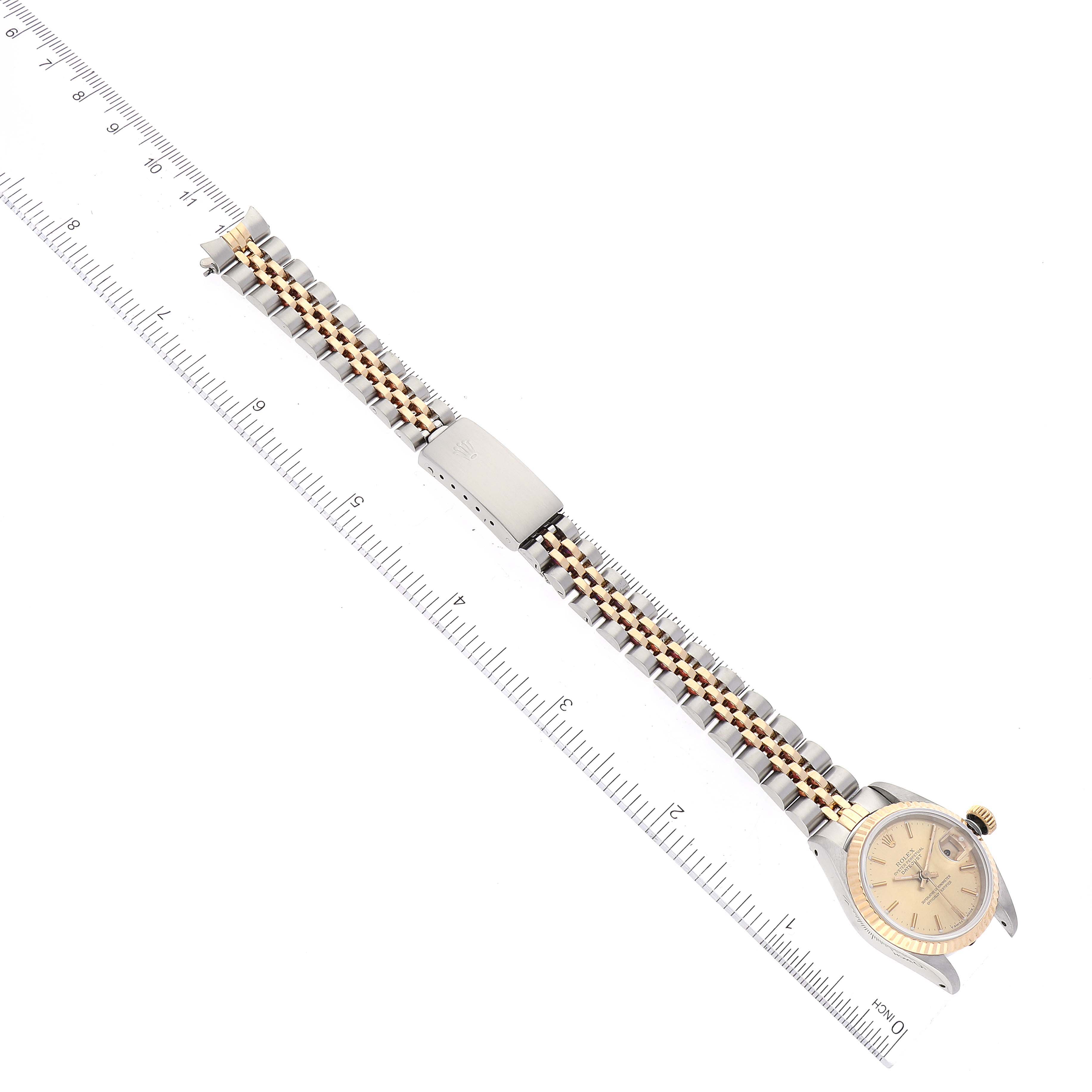 The photo shows a Rolex Datejust 69173 Women's Steel and Gold (two tone) Champagne Dial 69173 Women's Steel and Gold (two tone) Champagne Dial watch laid flat, displaying the entire band, clasp, and face at a slightly angled top-down perspective.